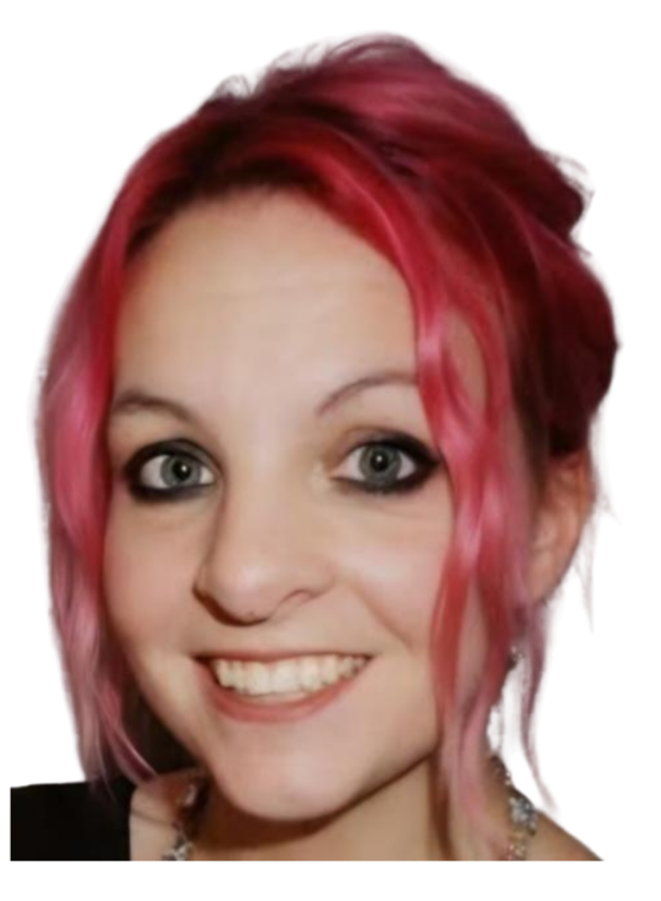 A woman with red hair and gray eyes smiling at the camera.