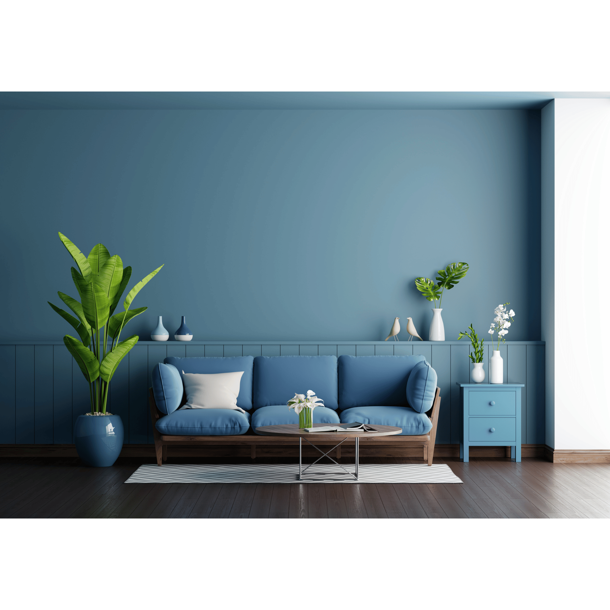Living room with blue walls, blue sofa, white cushion, a round coffee table with a glass top, white vases with flowers, large green plants, and a striped rug.