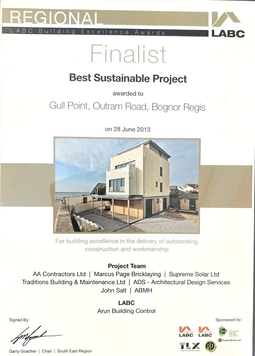 Award certificate for Gull Point, Outram Road, Bognor Regis as a finalist in the Best Sustainable Project category at the LABC Building Excellence Awards, dated June 28, 2013. Contains a photo of a modern, multi-story house with large windows, set in a coastal area.