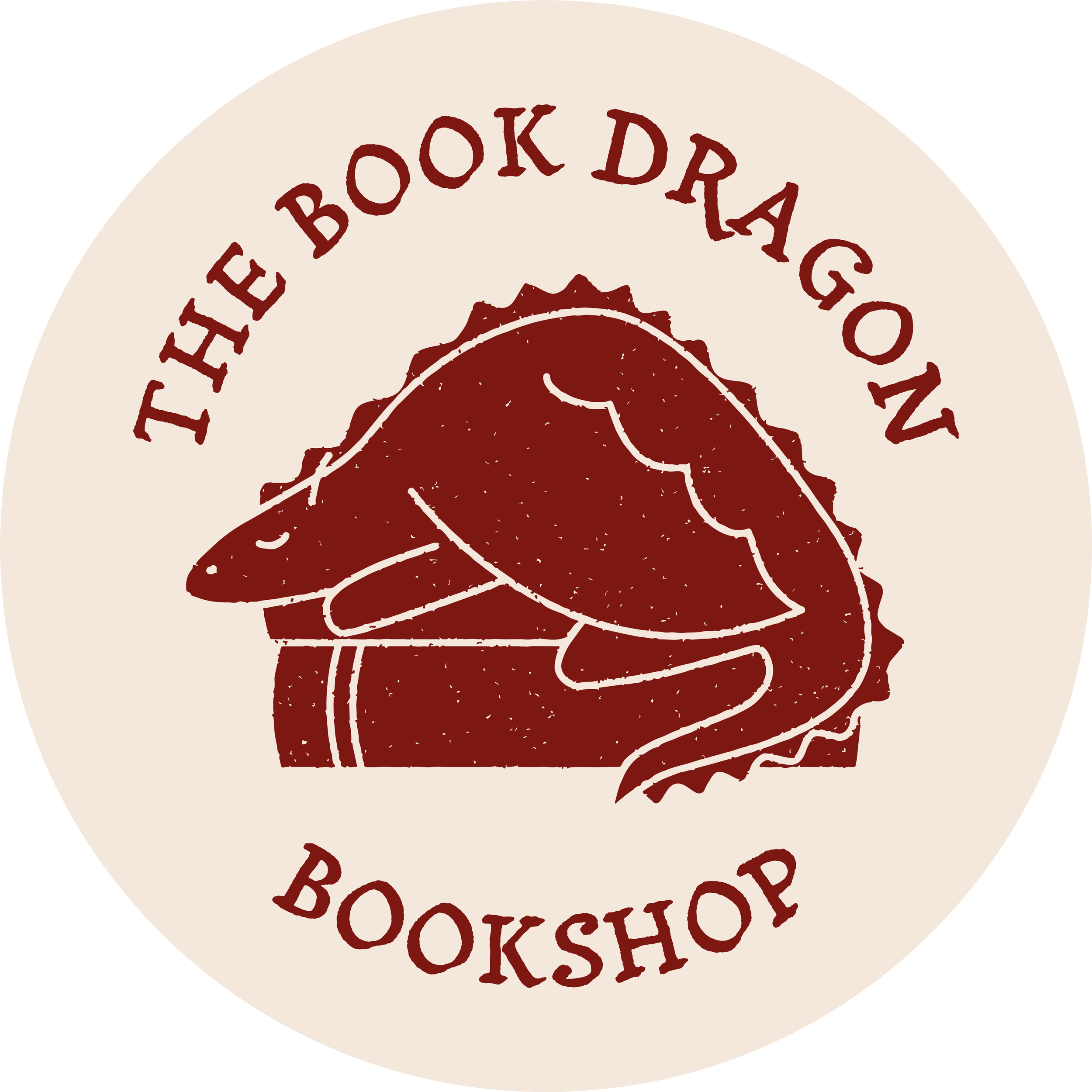Close-up of a circular logo with the words 'The Book Dragoons' and 'BOOKSHOP' in maroon on a cream background, featuring a stylized book illustration.