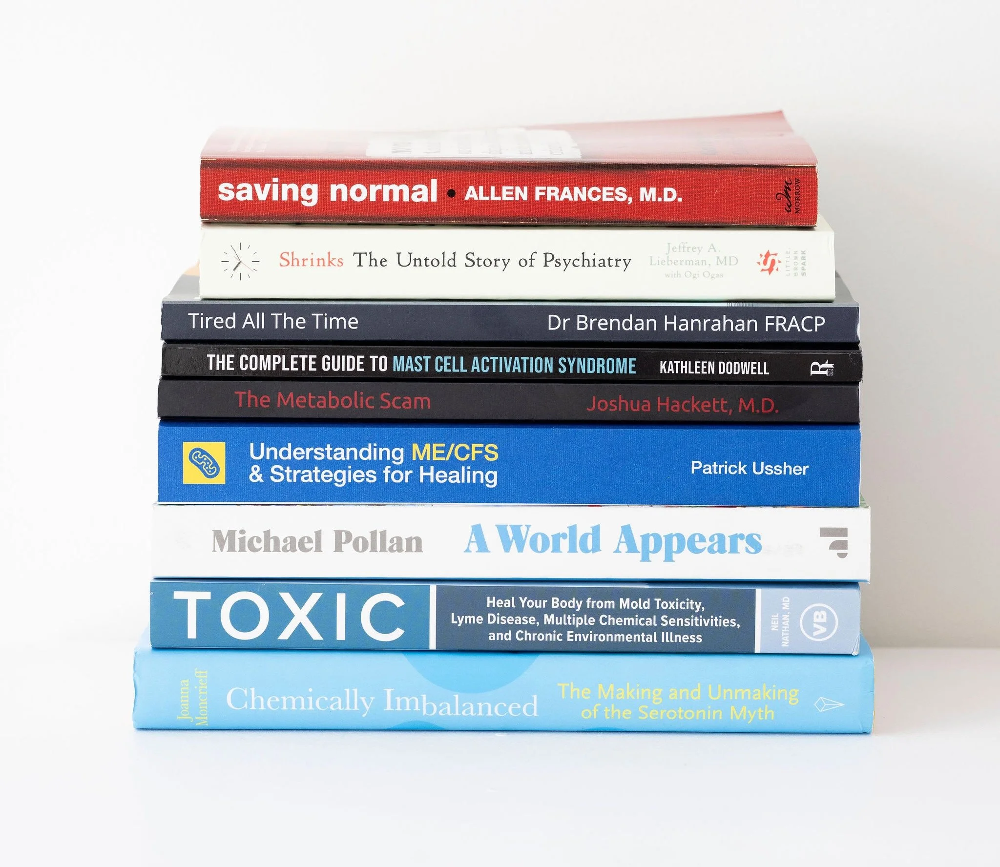 Stack of books on functional medicine and mental health