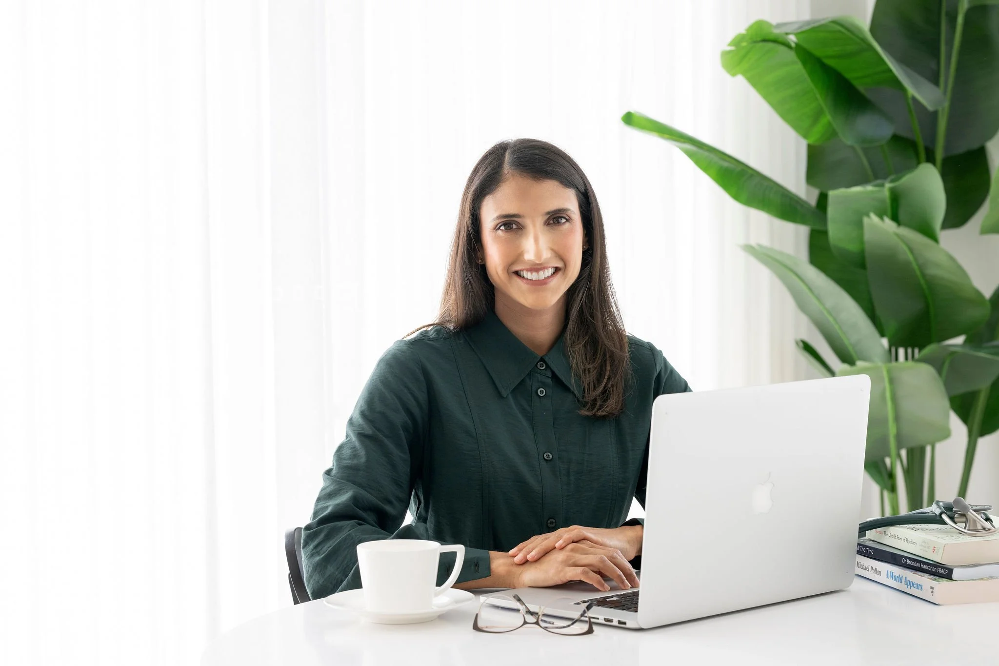Dr Chloe Tyson working at her desk in Brisbane clinic
