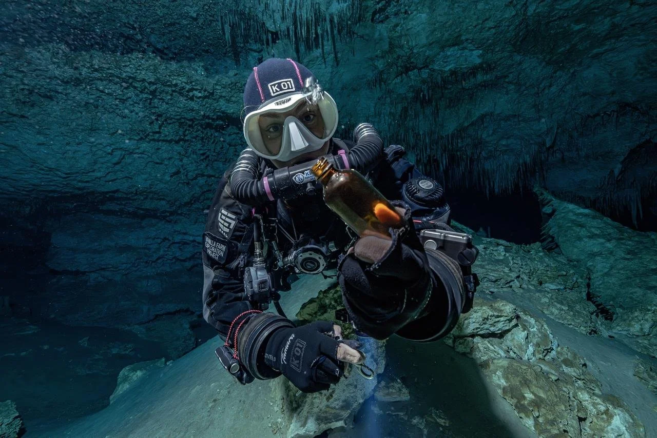 Cave diver Tamara Adame taking a water sample to be analyzed later