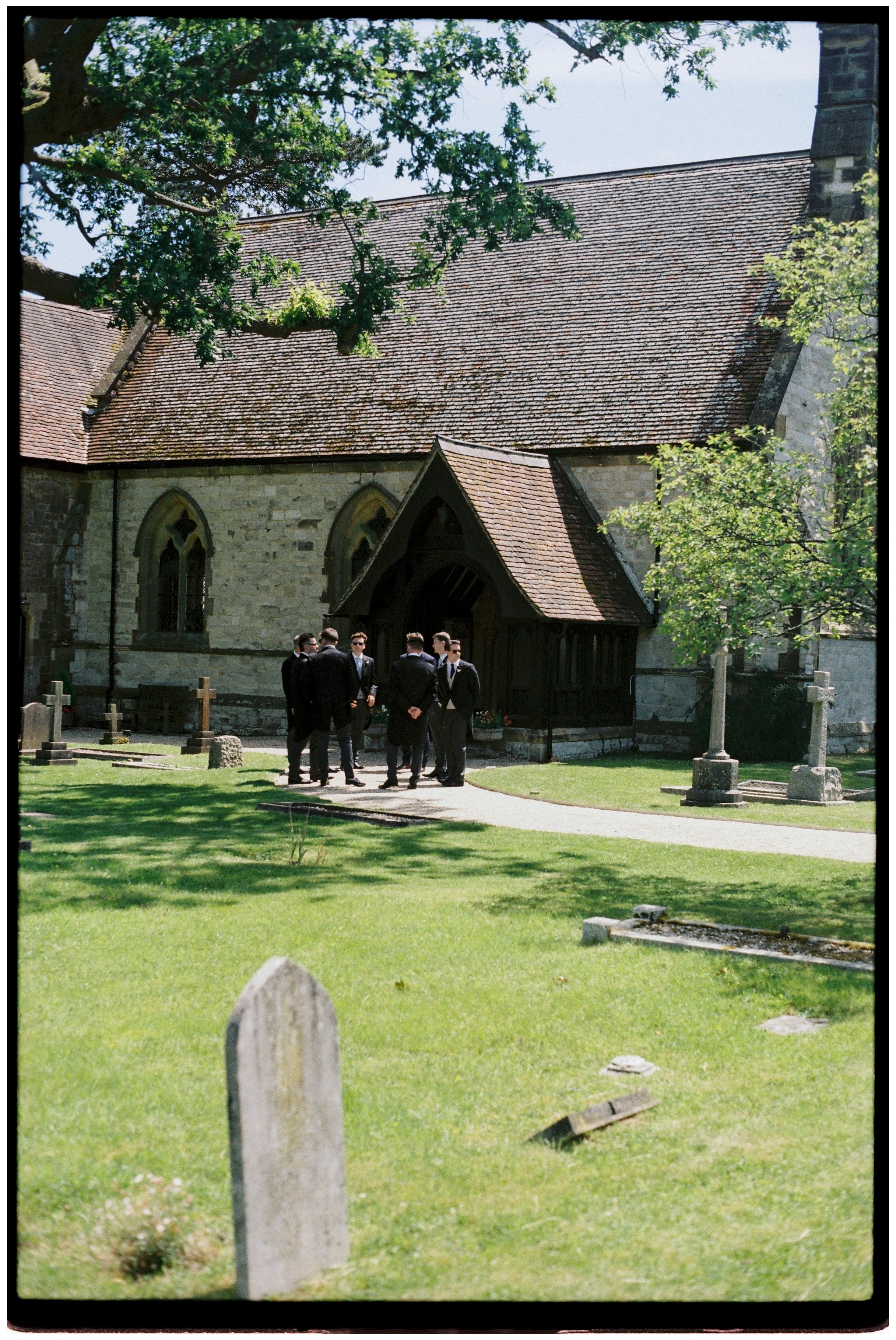 Groom and groomsmen outside Underhill Church in Sevenoaks, captured on 35mm film