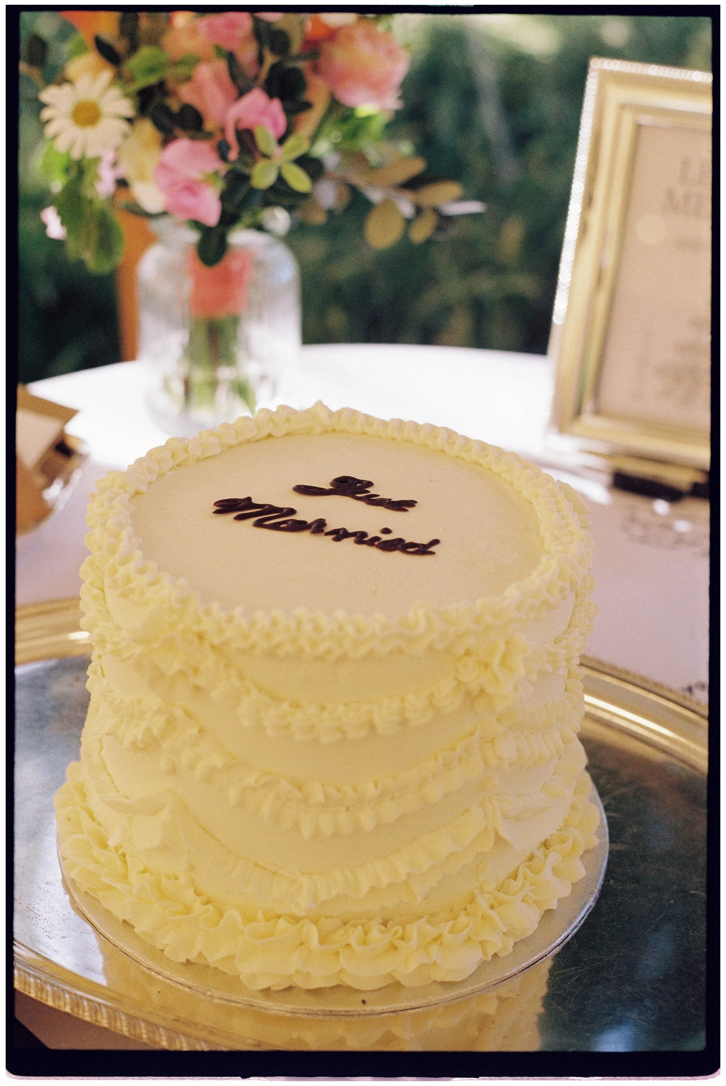White wedding cake decorated with piped icing at a Sevenoaks wedding, captured on Kodak Gold 35mm film