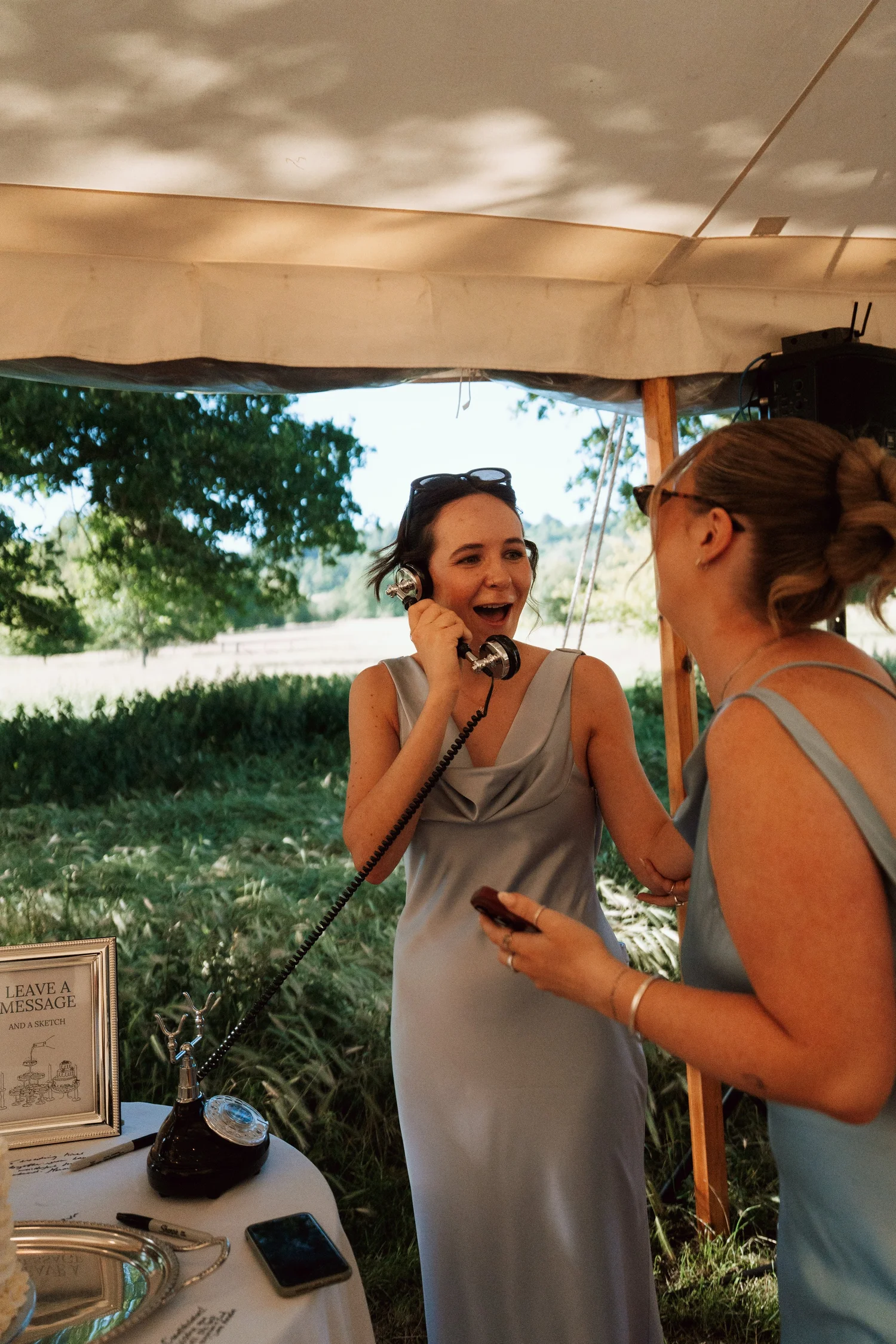 Two bridesmaids laughing together