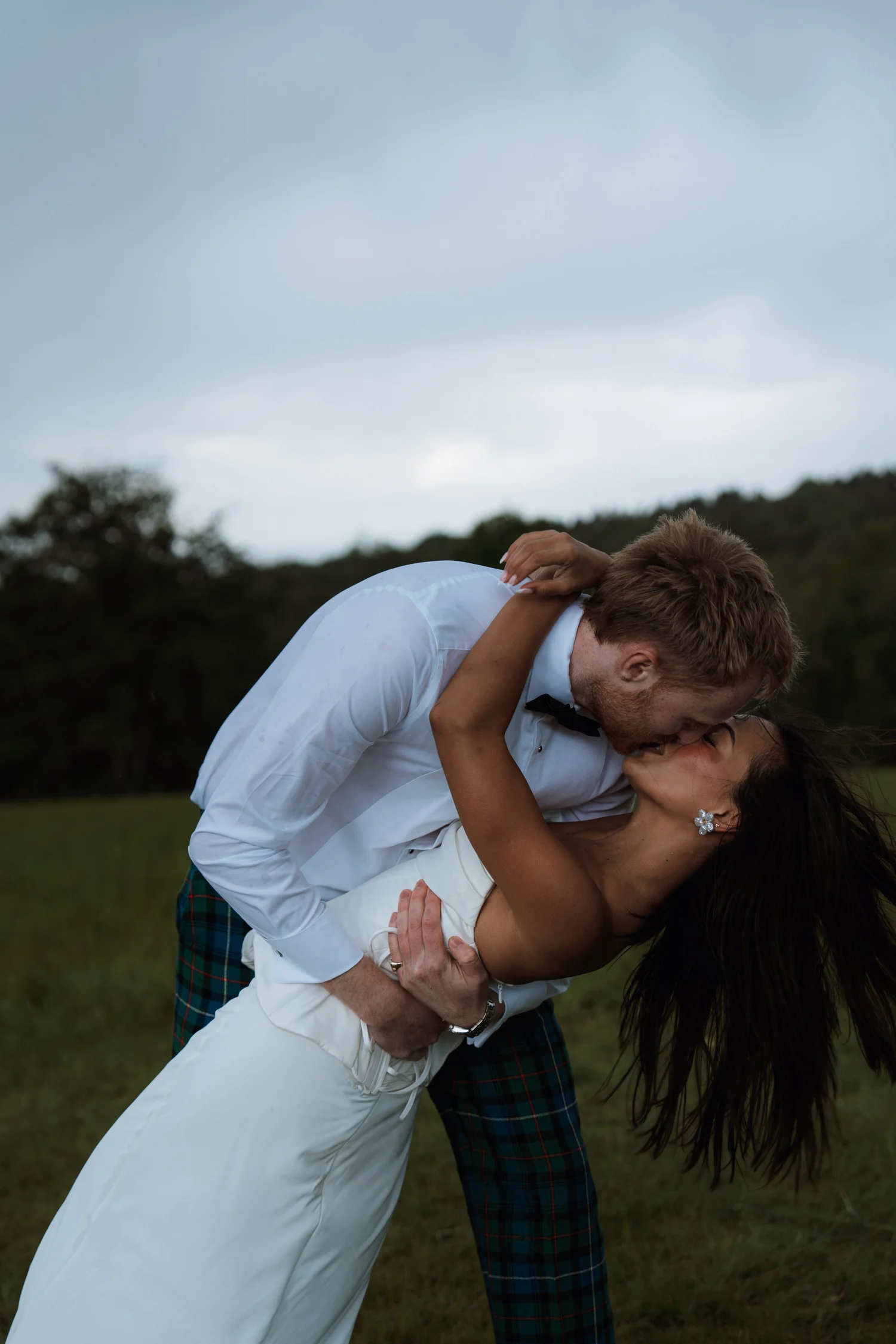 Couple kissing in a colour wedding portrait