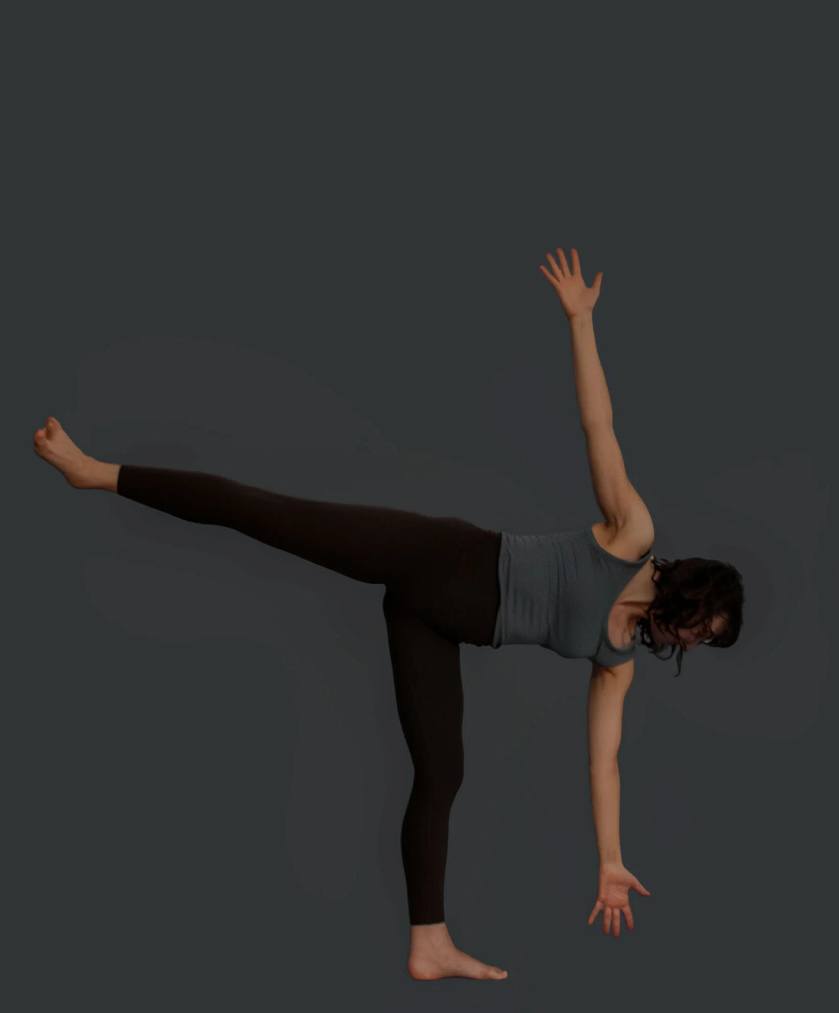 A woman practicing yoga in a yoga pose, standing on one leg with the other leg extended horizontally, one arm reaching forward, and the other arm raised above her head, against a dark gray background.
