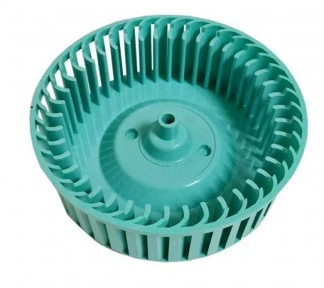 A teal plastic circular fan blade or impeller with evenly spaced vertical fins.