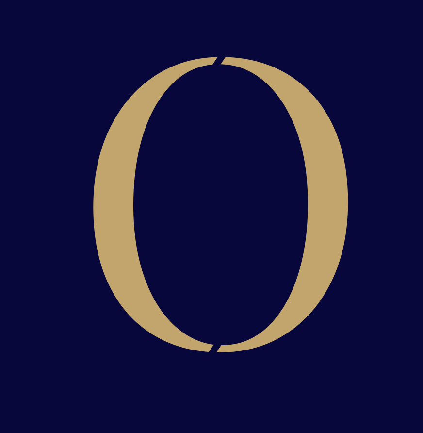 Close-up of a large, gold letter 'O' on a dark blue background.