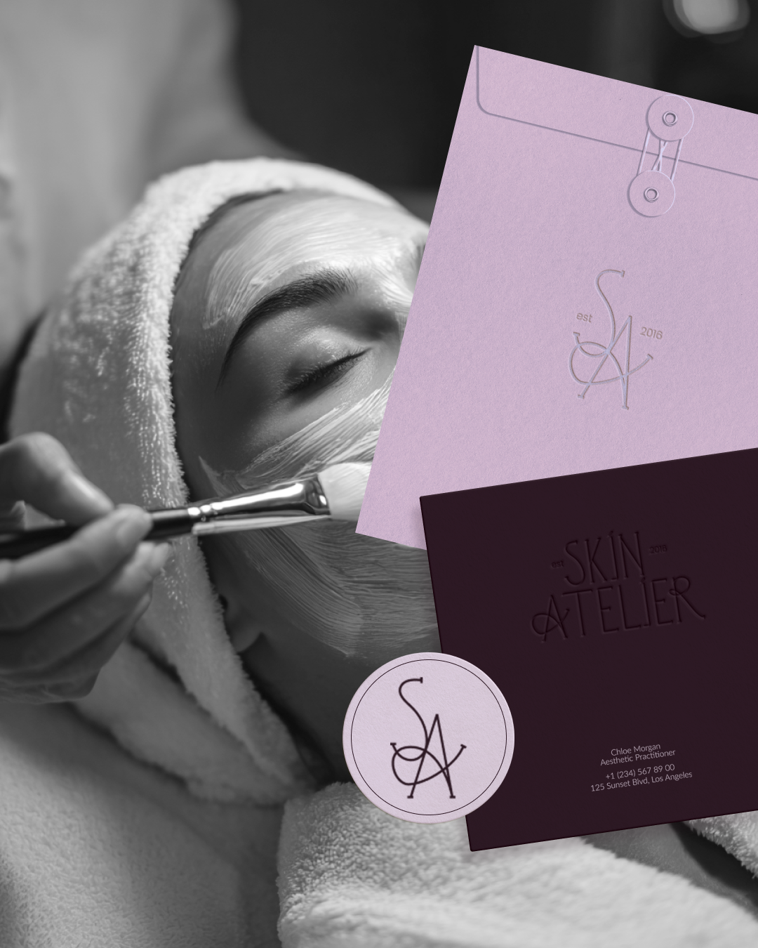 A woman receiving a facial treatment from an aesthetic practitioner, with skincare products and branding materials from Skin Atelier visible in the foreground.