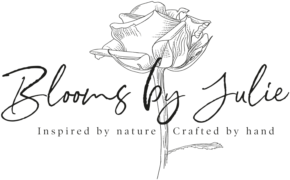 A logo with a hand-drawn rose, the text 'Blooms by Julie' in cursive, and the tagline 'Inspired by nature Crafted by hand' in smaller font.