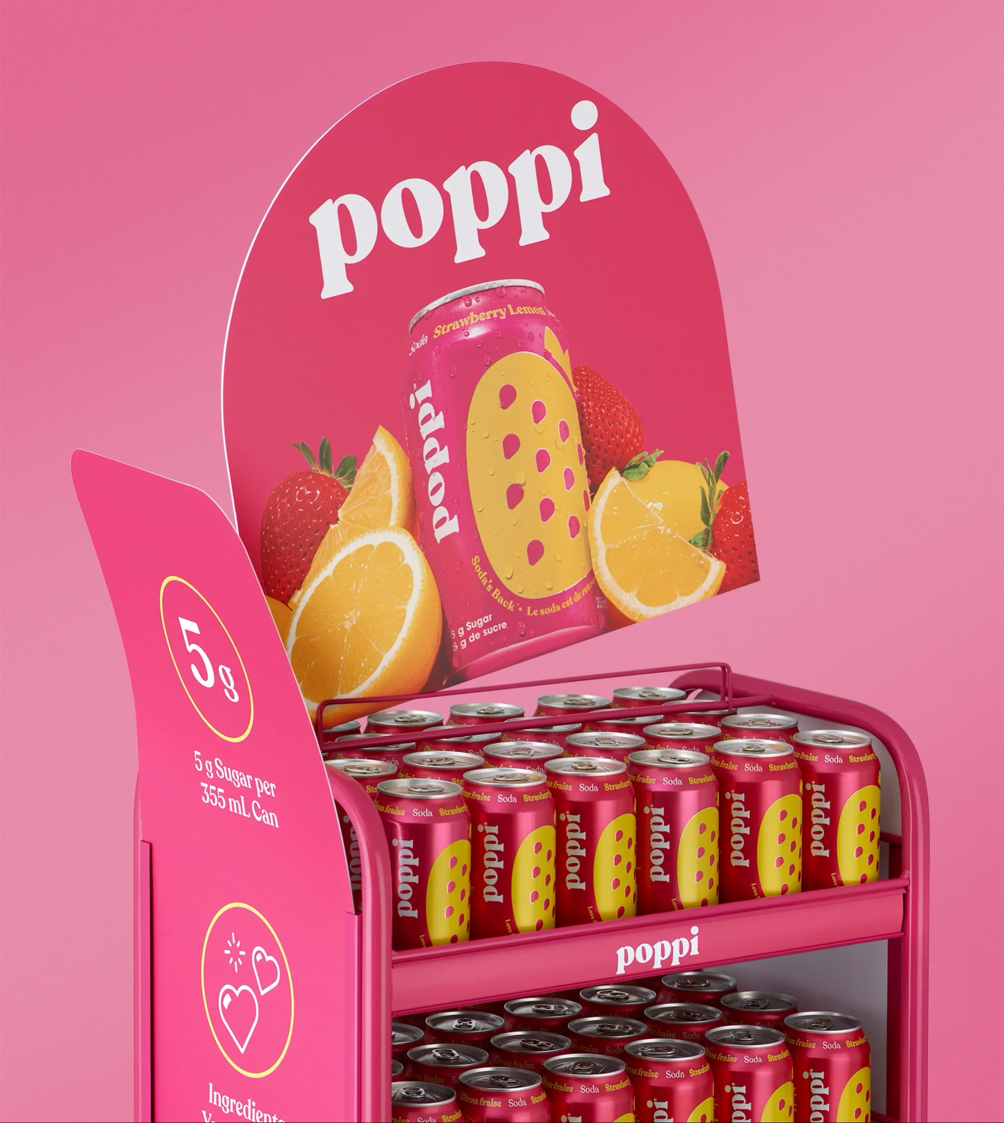 A pink display stand with cans of Poppi strawberry lemon soda, featuring images of strawberries and lemon slices, with promotional text indicating 5 grams of sugar per 355 ml can.