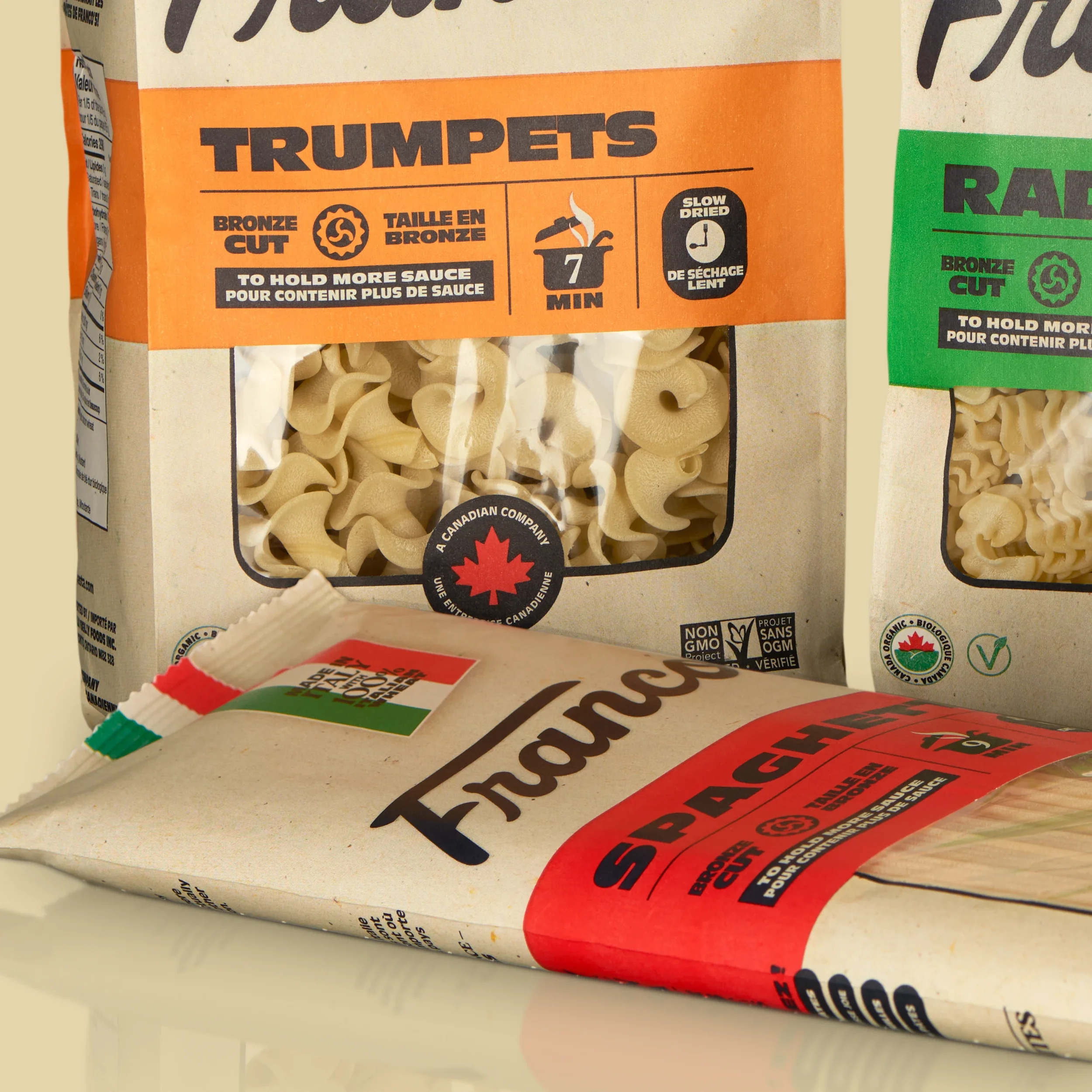 Franco's Pasta Spaghetti bag lying flat, showing the red variant colour coding against the natural kraft packaging