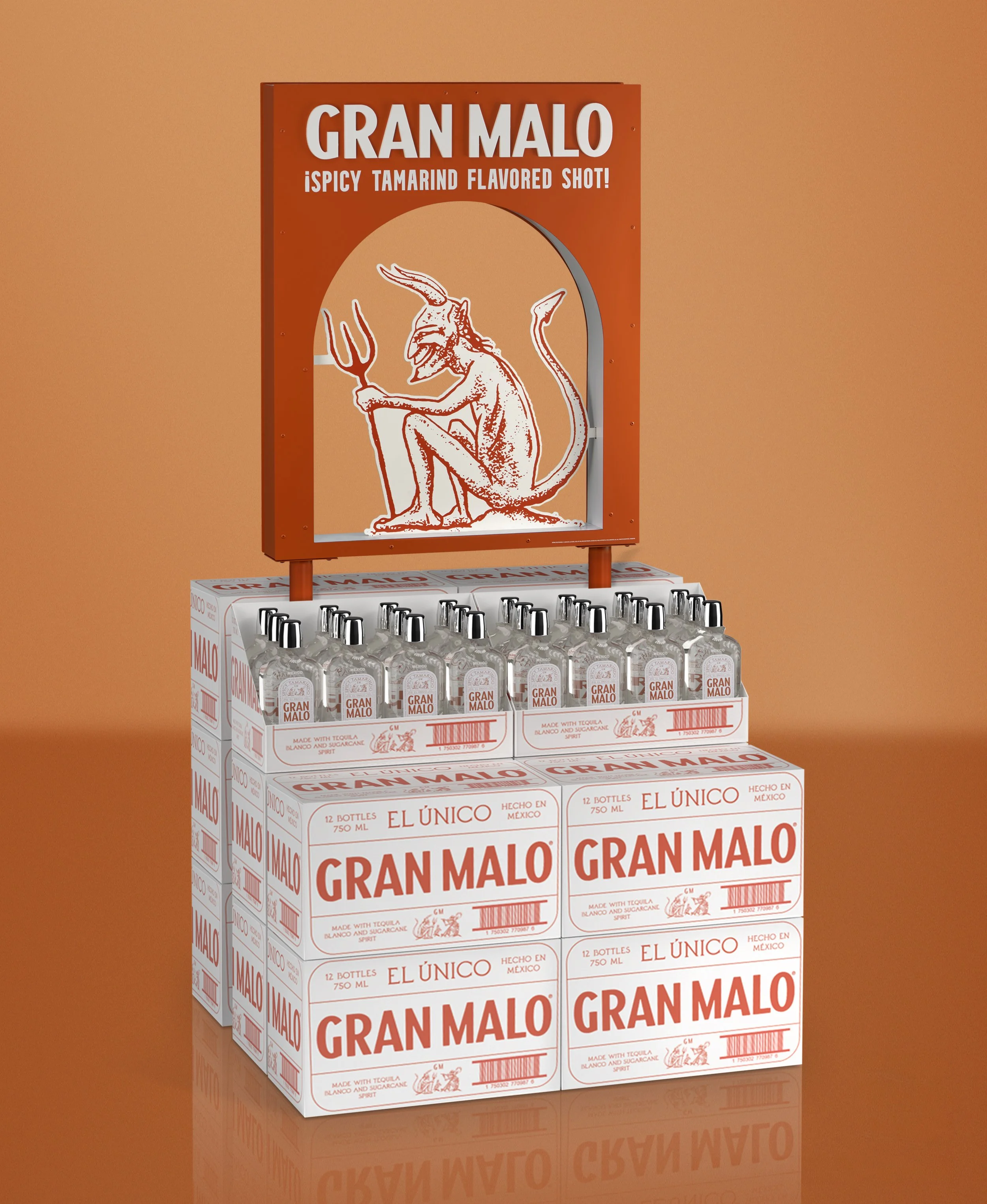 Display of Gran Malo tequila bottles on top of their packaging boxes, featuring a red and white color scheme and a cartoon goat illustration.