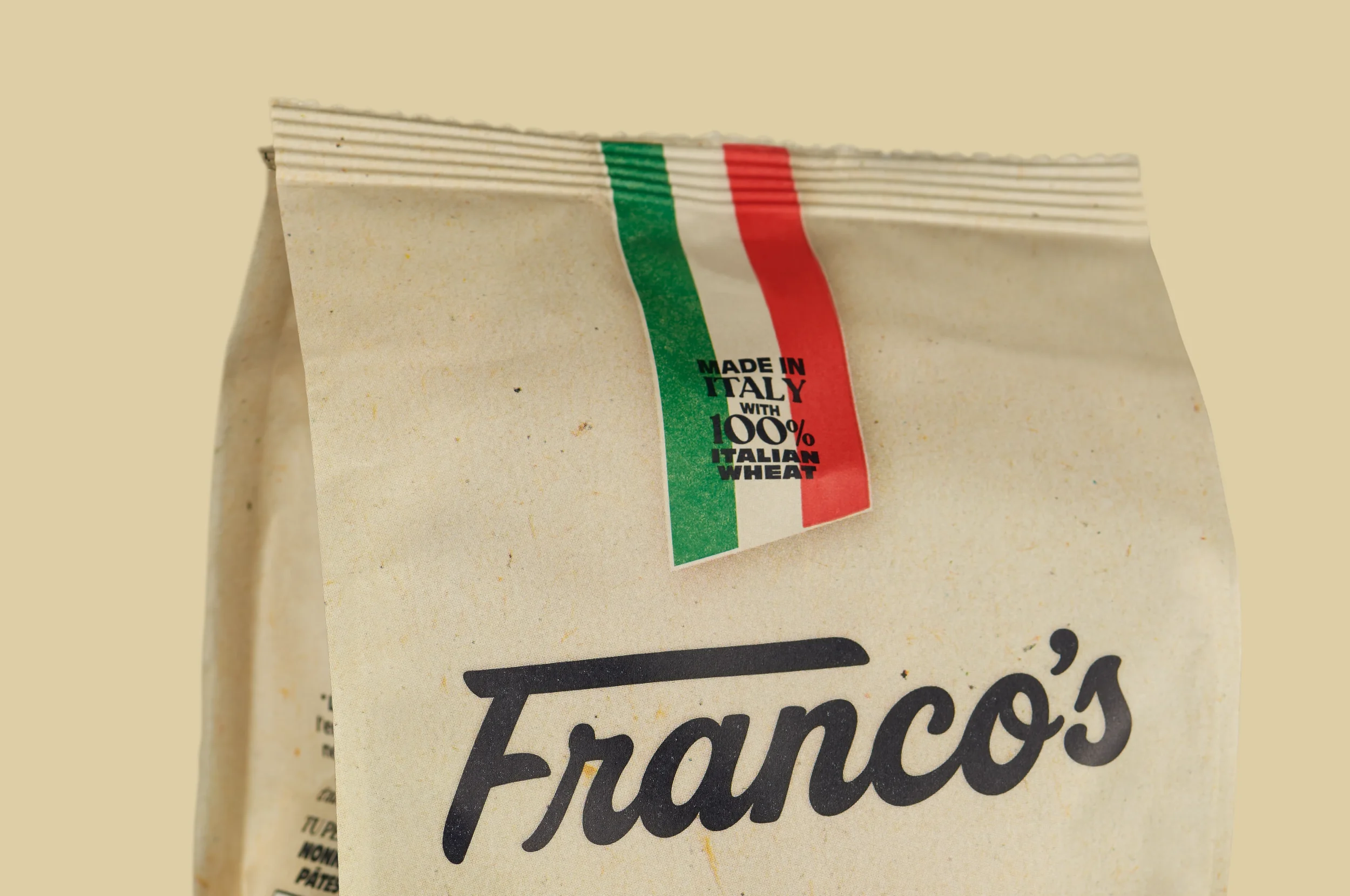 Franco's Pasta bag standing upright, showing the front logo and Italian heritage ribbon detail