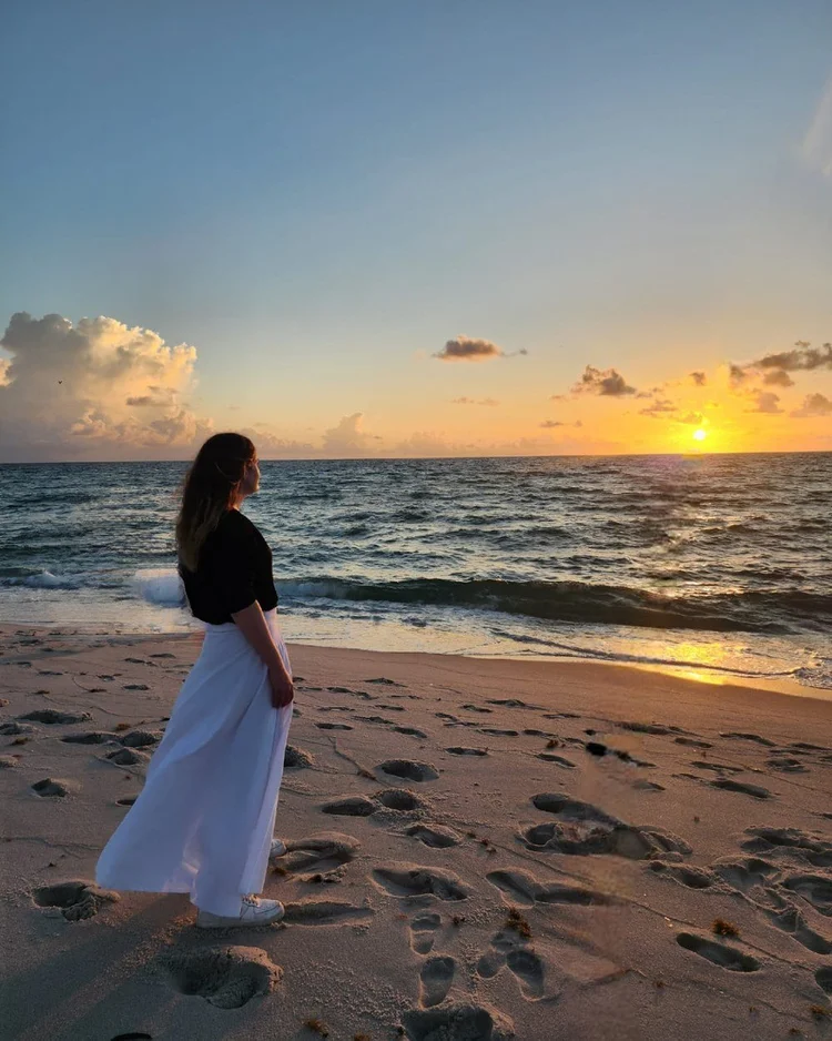 C.P. Handler standing on the beach at sunset