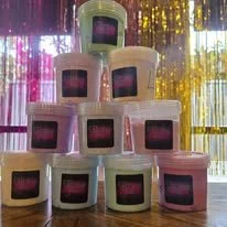 Stacked cardboard boxes with rainbow-colored screens displayed on them, arranged in a pyramid formation, with a shimmering, multicolored background.