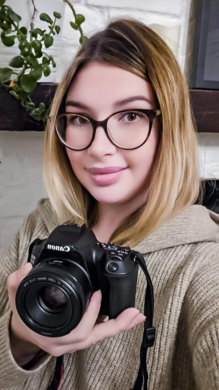 Portrait of Rachel Francesca, a newborn and family photographer, holding her camera and ready to capture natural family moments.