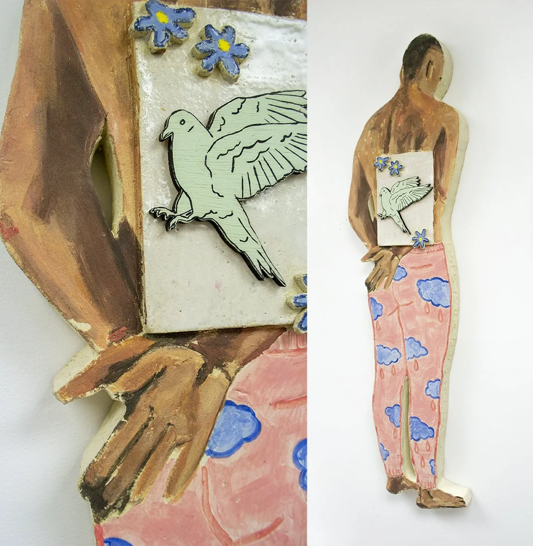 Mixed media art piece depicting a woman with a painted body as a cloudscape, holding a small wooden panel with a colored drawing of a bird and flowers. The art combines painting and carved wooden elements.