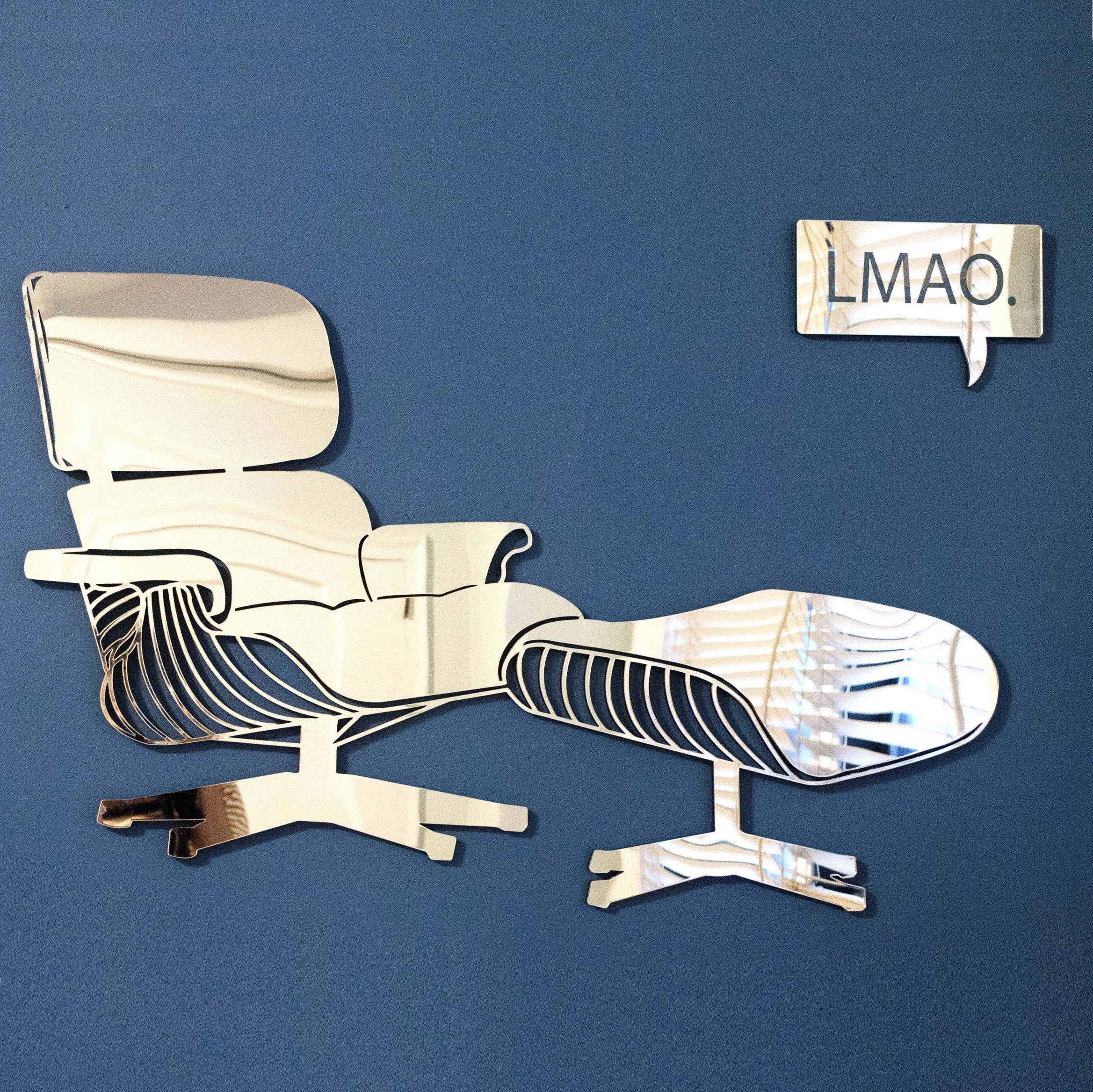 Decorative metal wall art featuring abstract line drawings of animals, including a zebra, against a blue background, with a speech bubble-shaped sign that reads "LMAO."