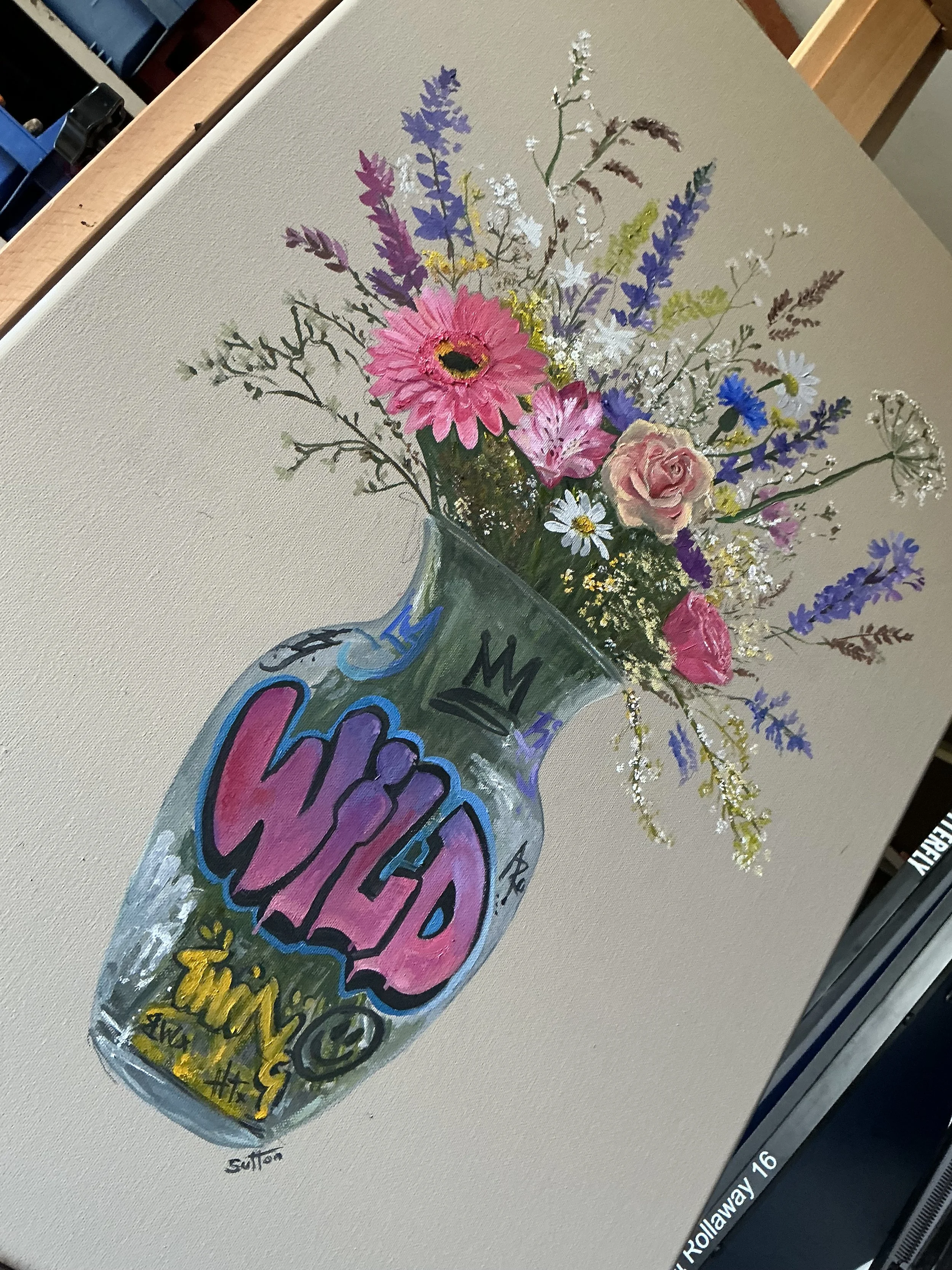 A painted canvas featuring a bouquet of colorful flowers in a jar, combined with graffiti-style text and symbols.