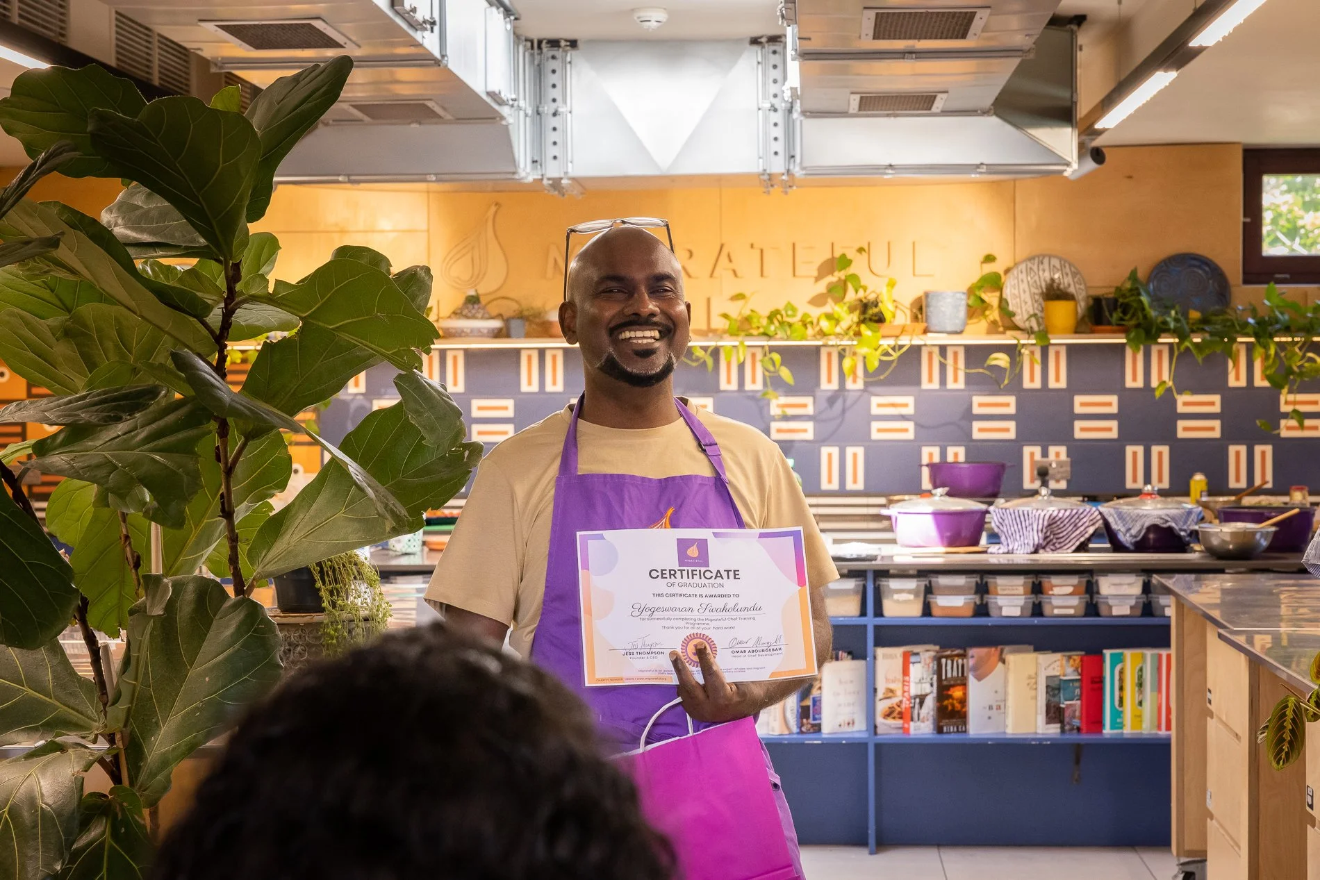 Yogi showing his graduation certificate (Image credit: Migrateful)