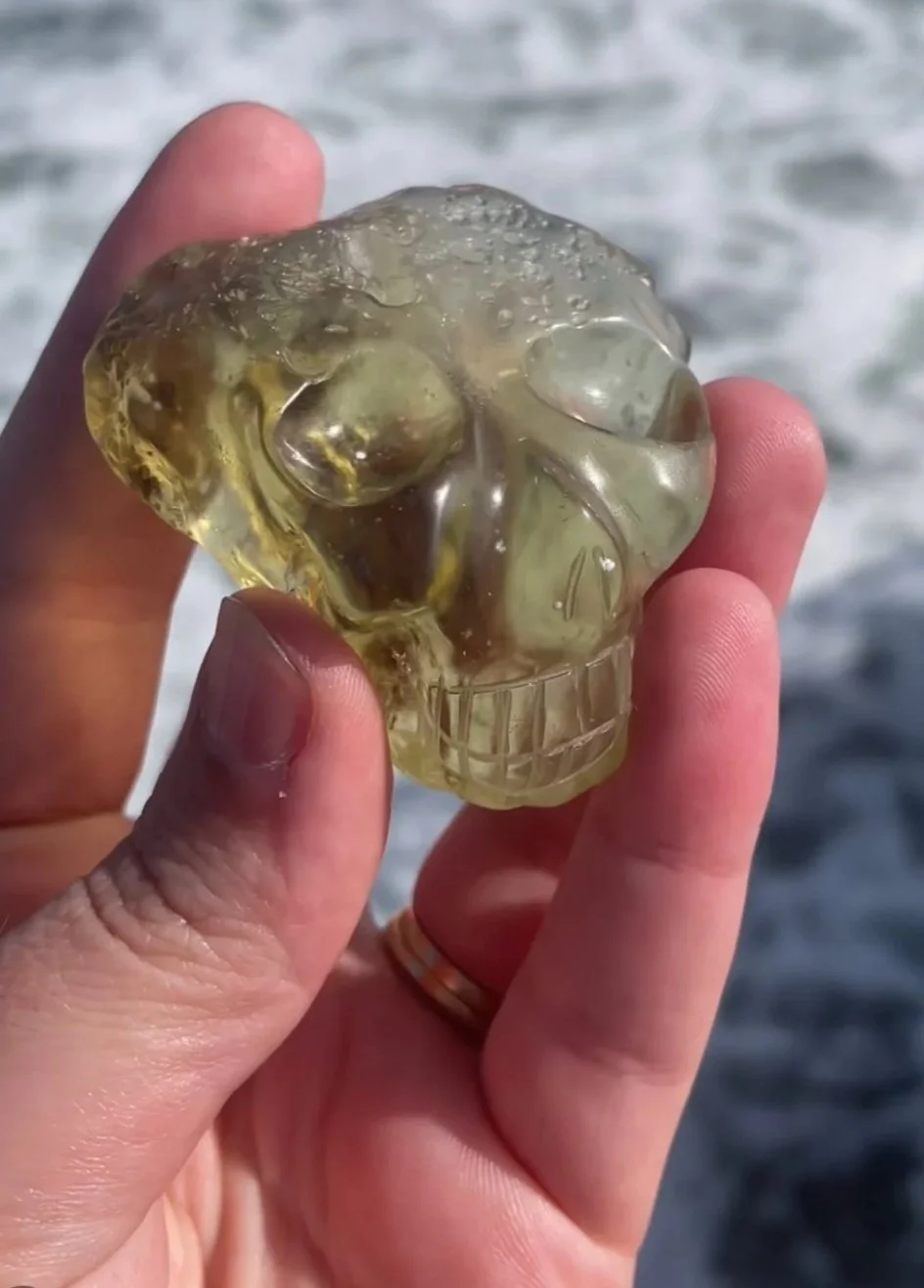Bizoin Libyan Desert Glass Palm Skull carved by Leandro de Souza in 2022.