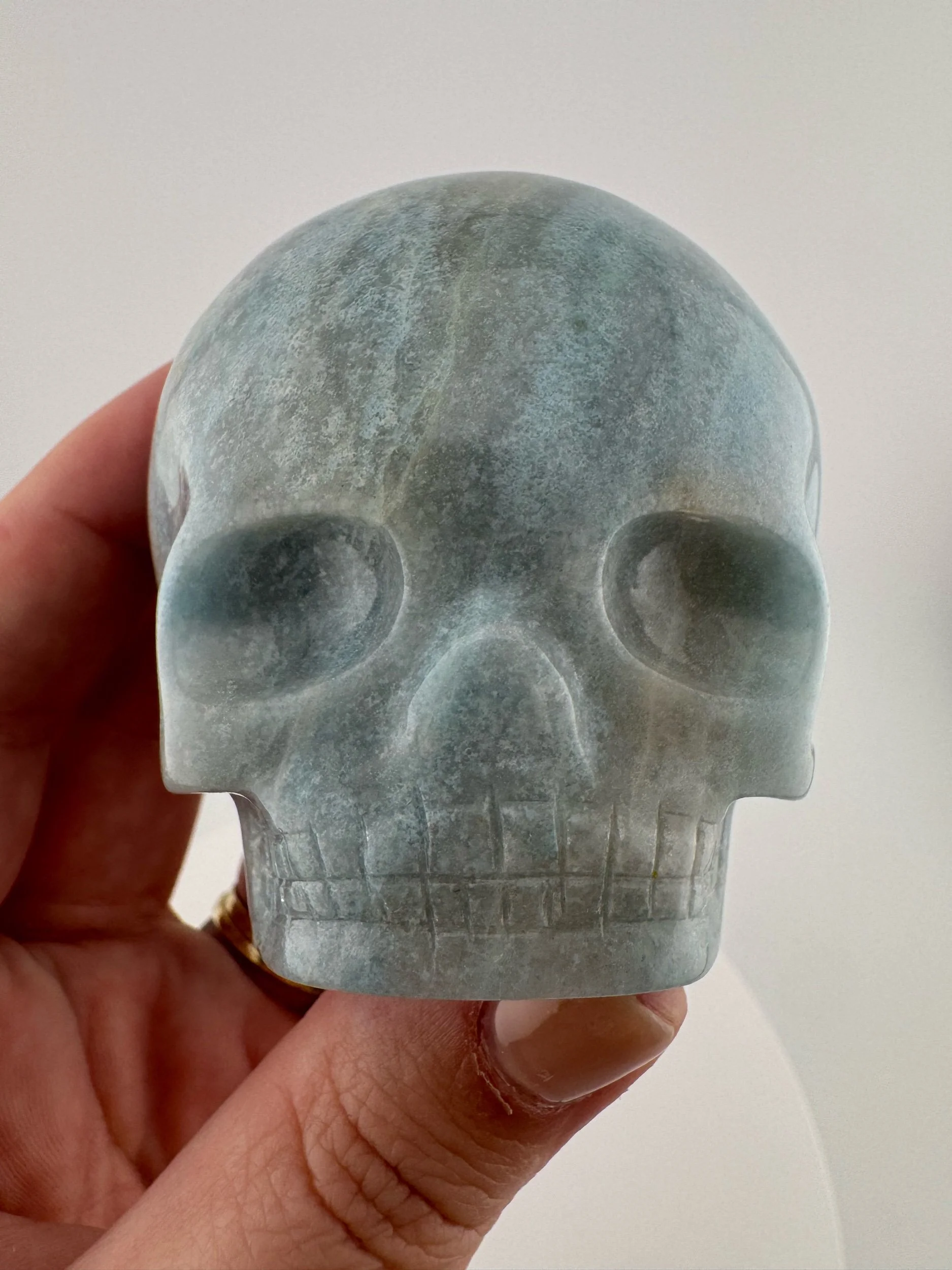 A Blue Trollite Magical Child Skull carved by Leandro de Souza