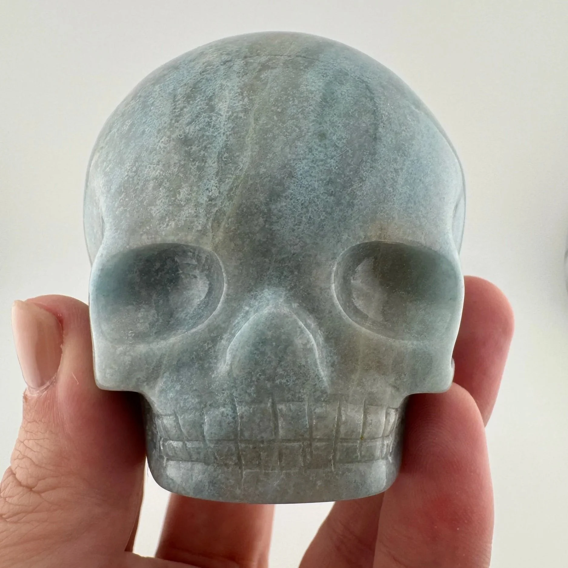 A Blue Trollite Magical Child Skull carved by Leandro de Souza
