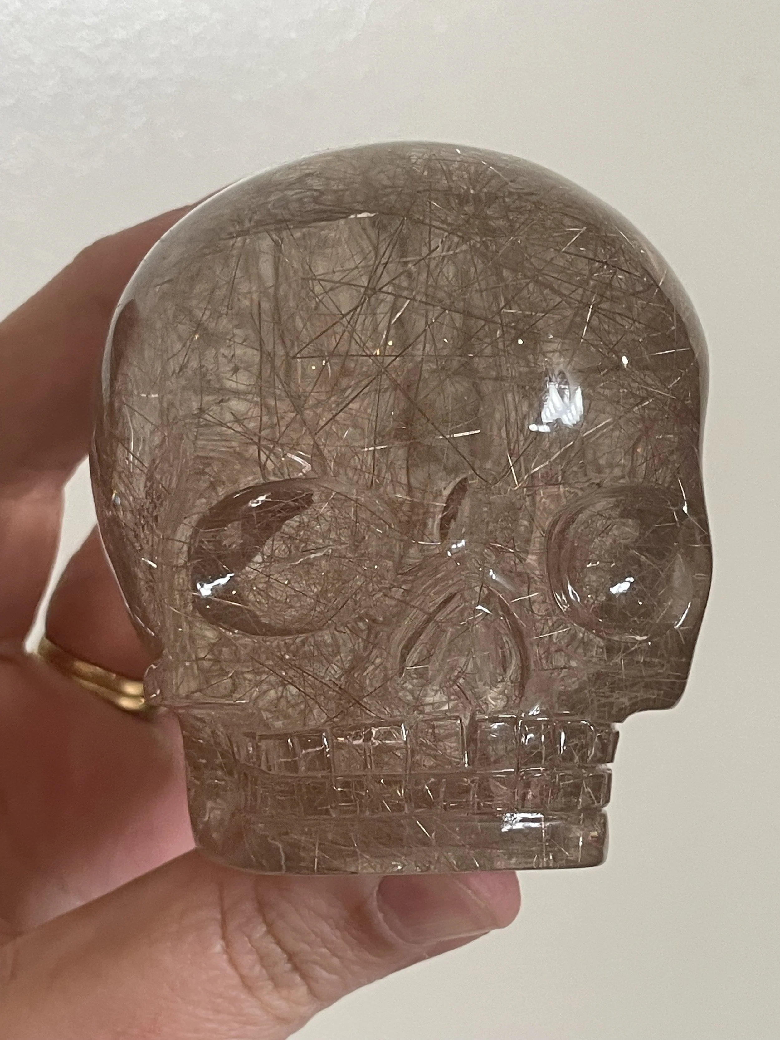 Red Rutile in Quartz Magical Child Skull carved by Leandro de Souza in 2023.