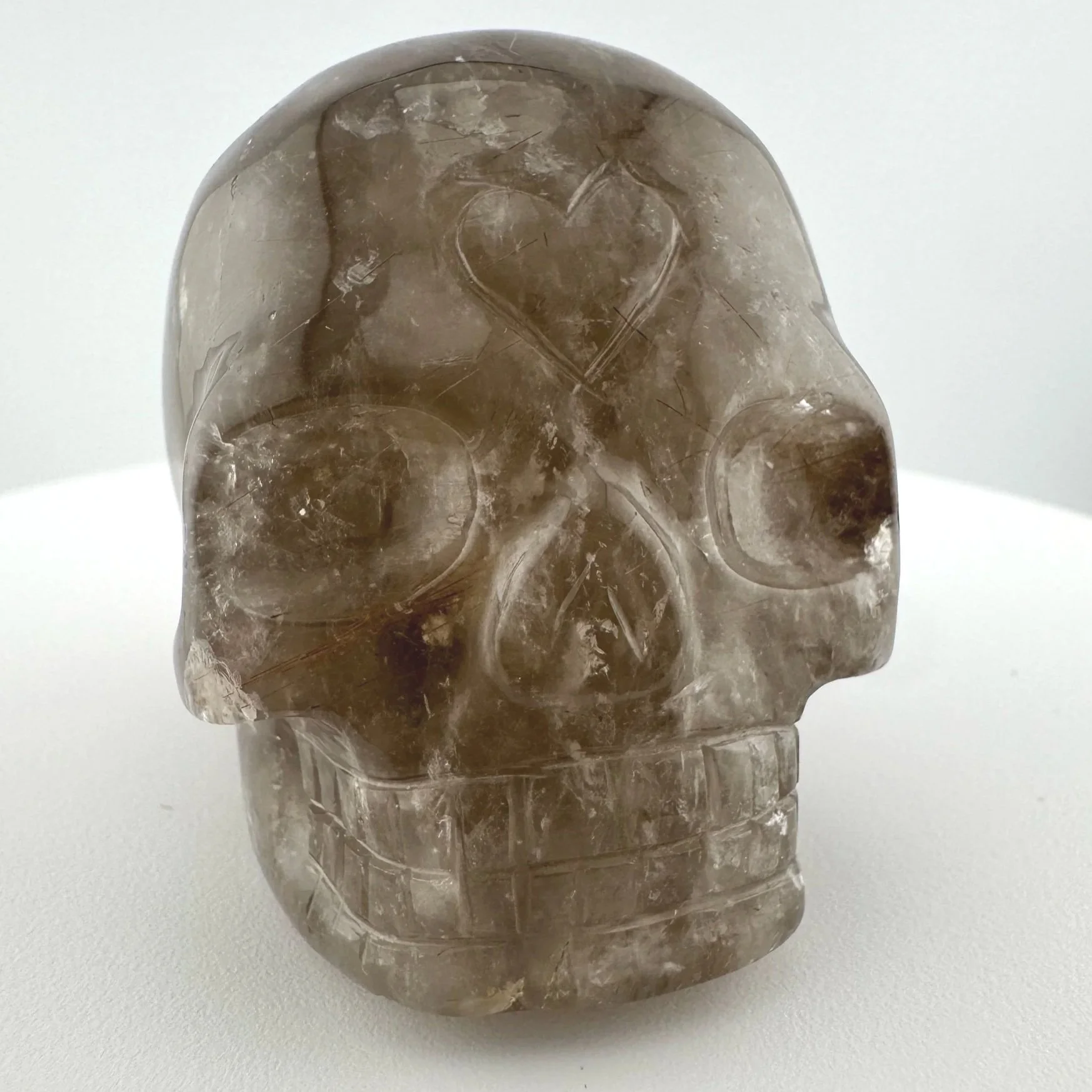 Red Rutile in Smoky Quartz Skull carved by Leandro de Souza