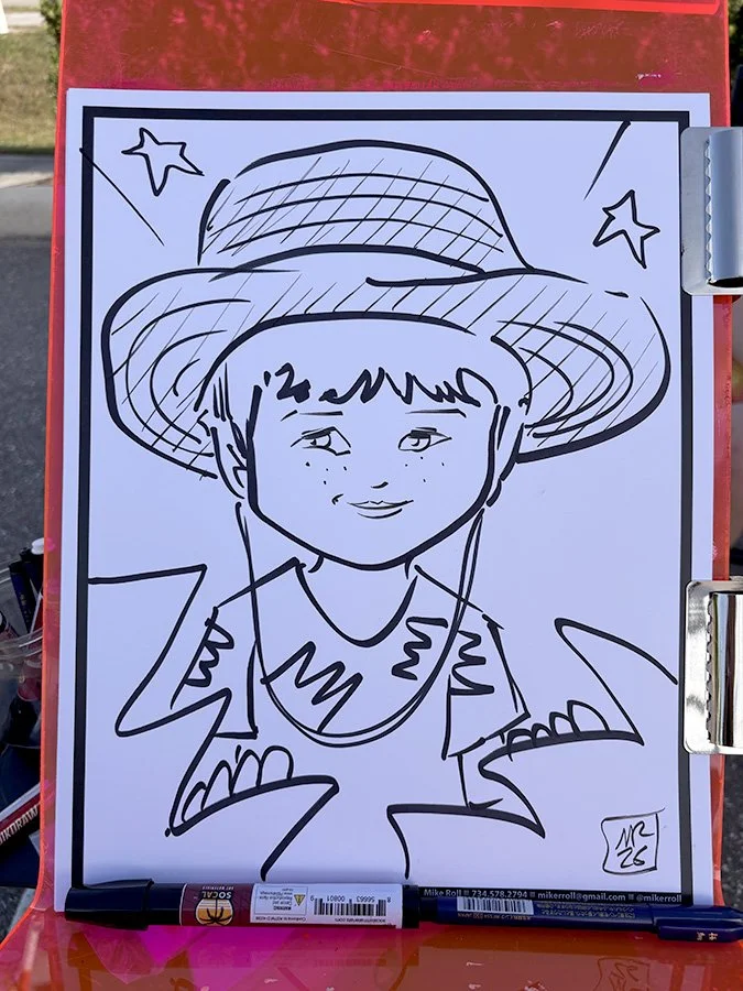 A black-and-white line drawing of a young boy wearing a wide-brimmed hat with stars and lines for decoration, a collared shirt with a zigzag pattern, and a smile, on a piece of paper clipped to a red clipboard.
