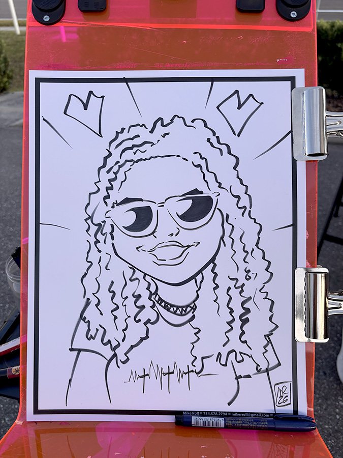 Line drawing of a woman with curly hair wearing sunglasses, a choker, and a t-shirt, smiling with two heart symbols above her head.