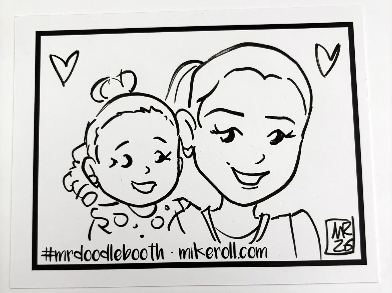 Black and white line drawing of two smiling women with hearts above their heads, one with curly hair and a bow and the other with short hair, wearing a bun, with hashtags #mrddoodlebooth and website mikeroll.com at the bottom.