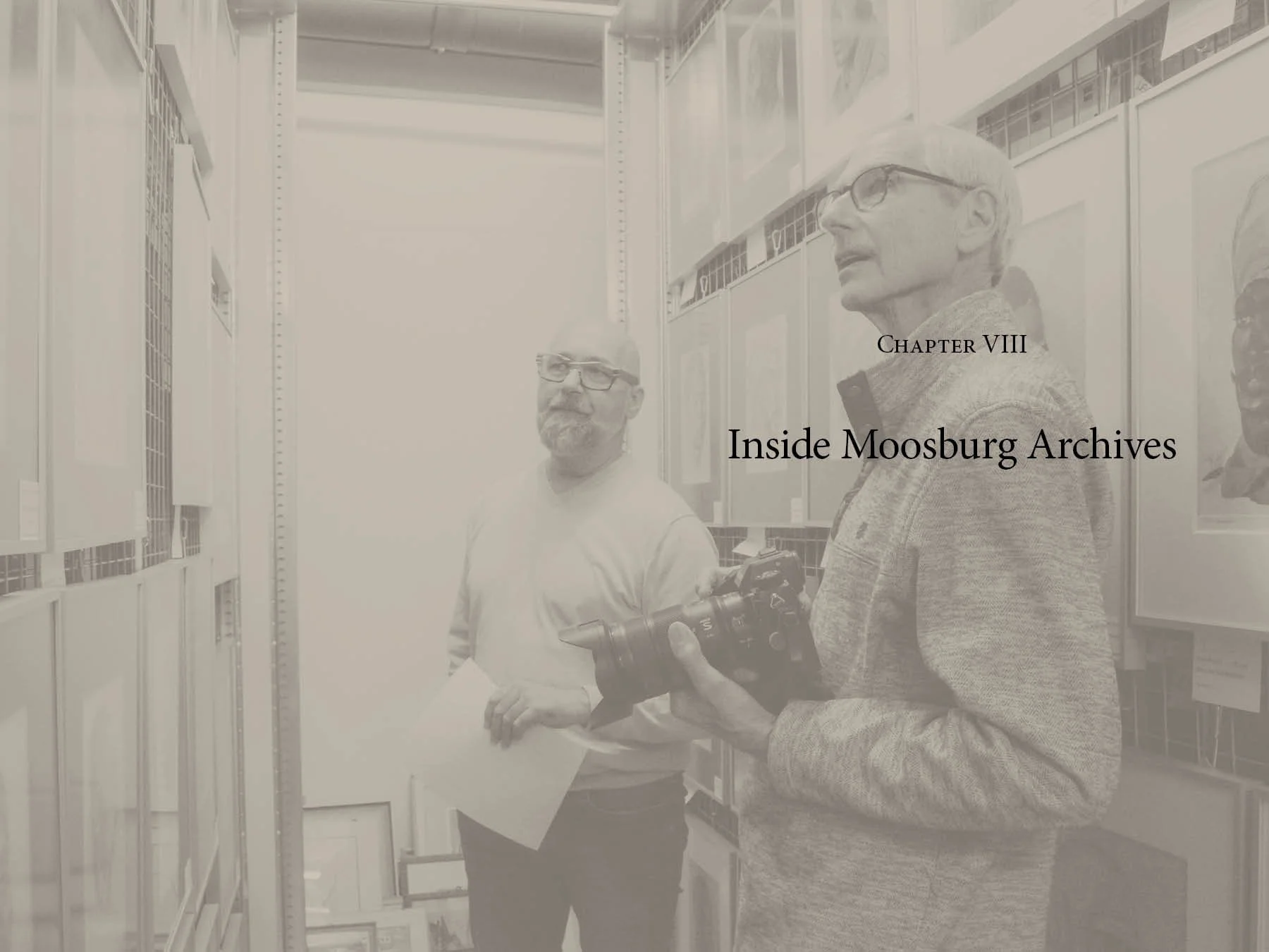 Two men standing in front of archival shelves with photographs and documents. One man is holding a camera, and the other is looking to the side. Text on the image reads 'Chapter VIII Inside Moosburg Archives.'