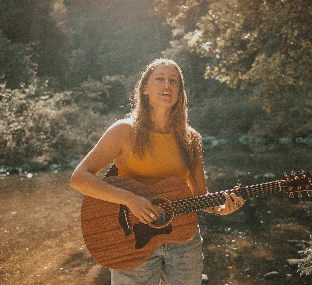 blonde person with guitar