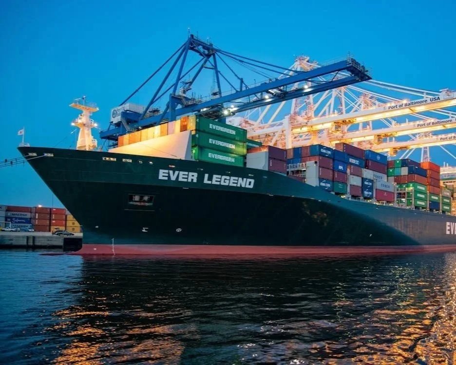 Cargo ship named 'Ever Legend' docked at the port of Baltimore USA, with many containers and cranes for loading and unloading.