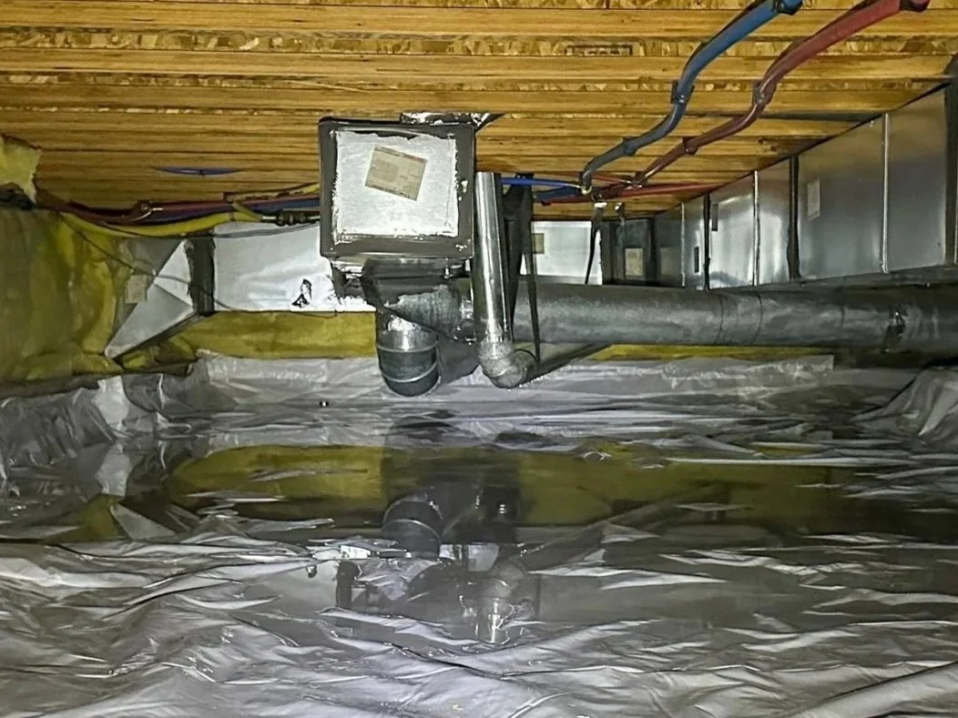 Standing water on top of a crawl space liner caused by condensation from high humidity