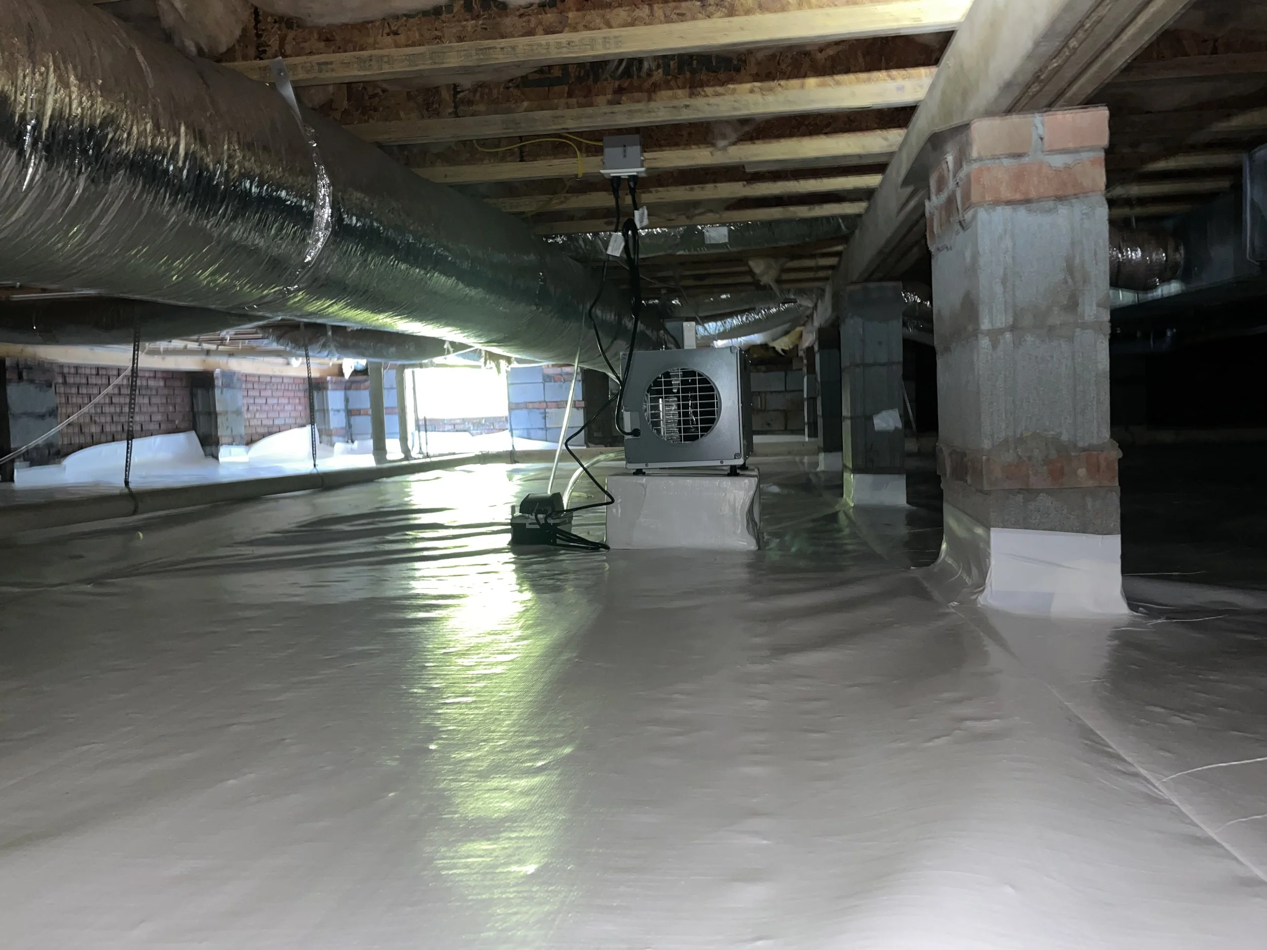 Encapsulated crawl space in Sherrills Ford with a sealed vapor barrier, wrapped piers and crawl space dehumidifier
