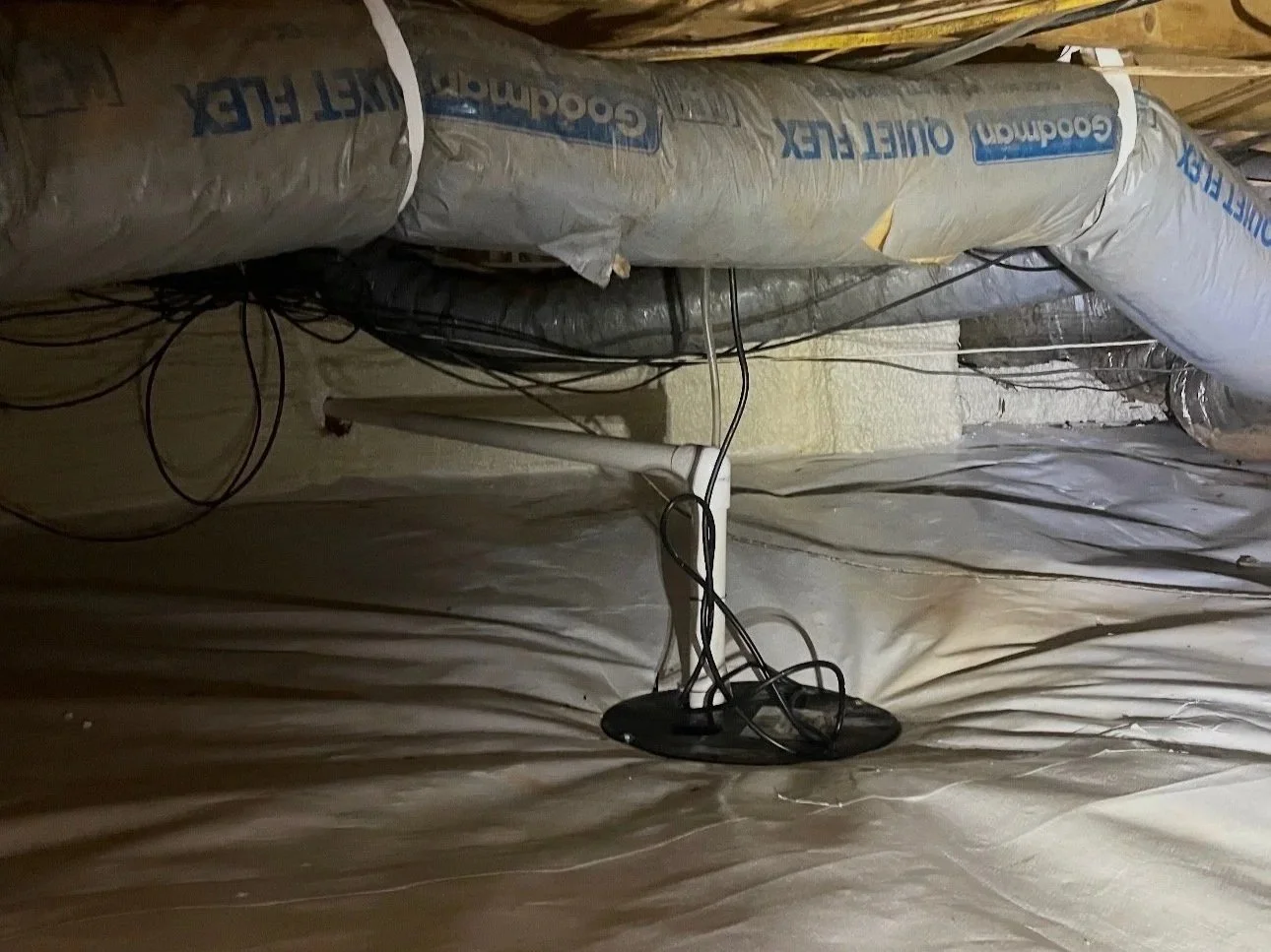 Sealed crawl space with interior drainage and sump pump system for collecting and removing water beneath the home.