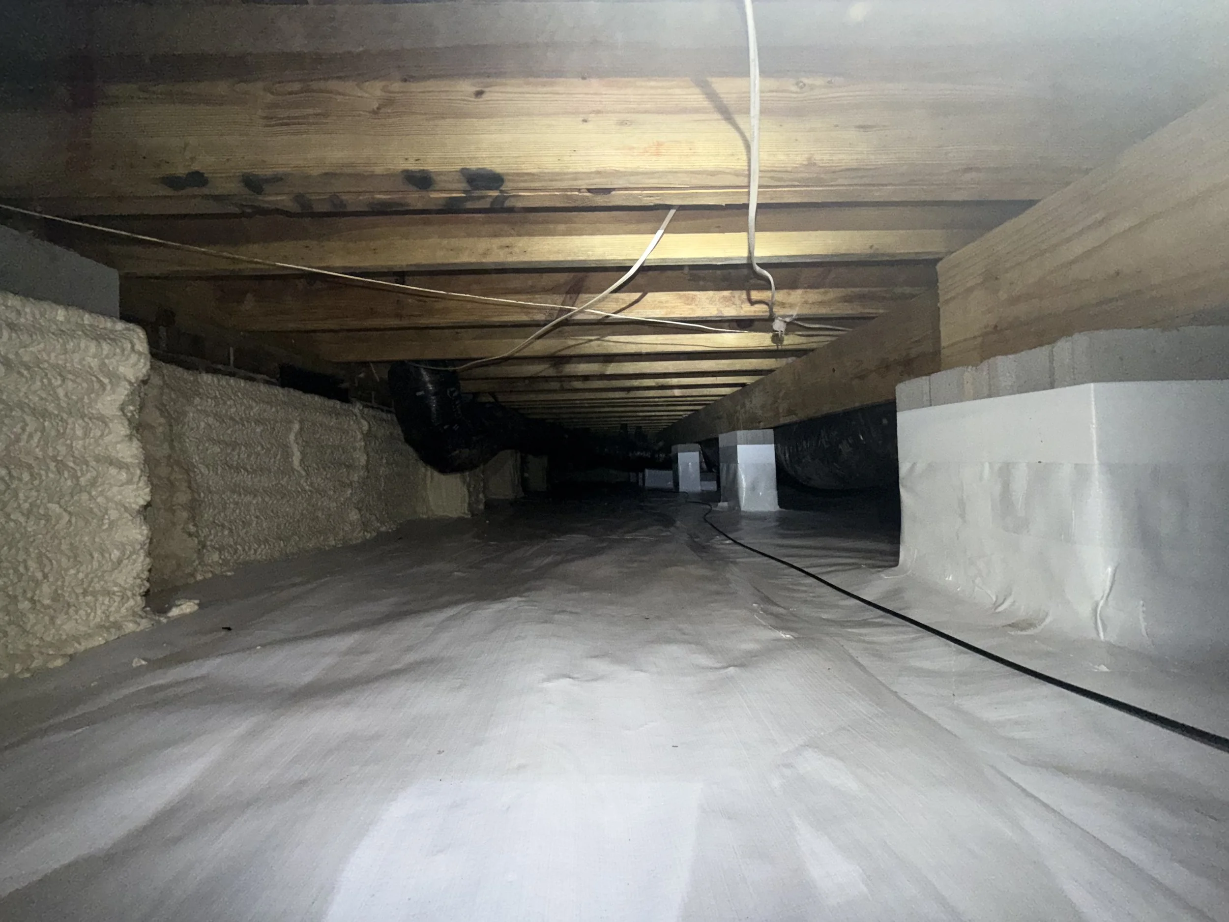 Completed Charlotte crawl space refresh with mold-remediated floor joists, full encapsulation, wrapped walls and piers, spray-foam insulation and an AprilAire® dehumidifier.
