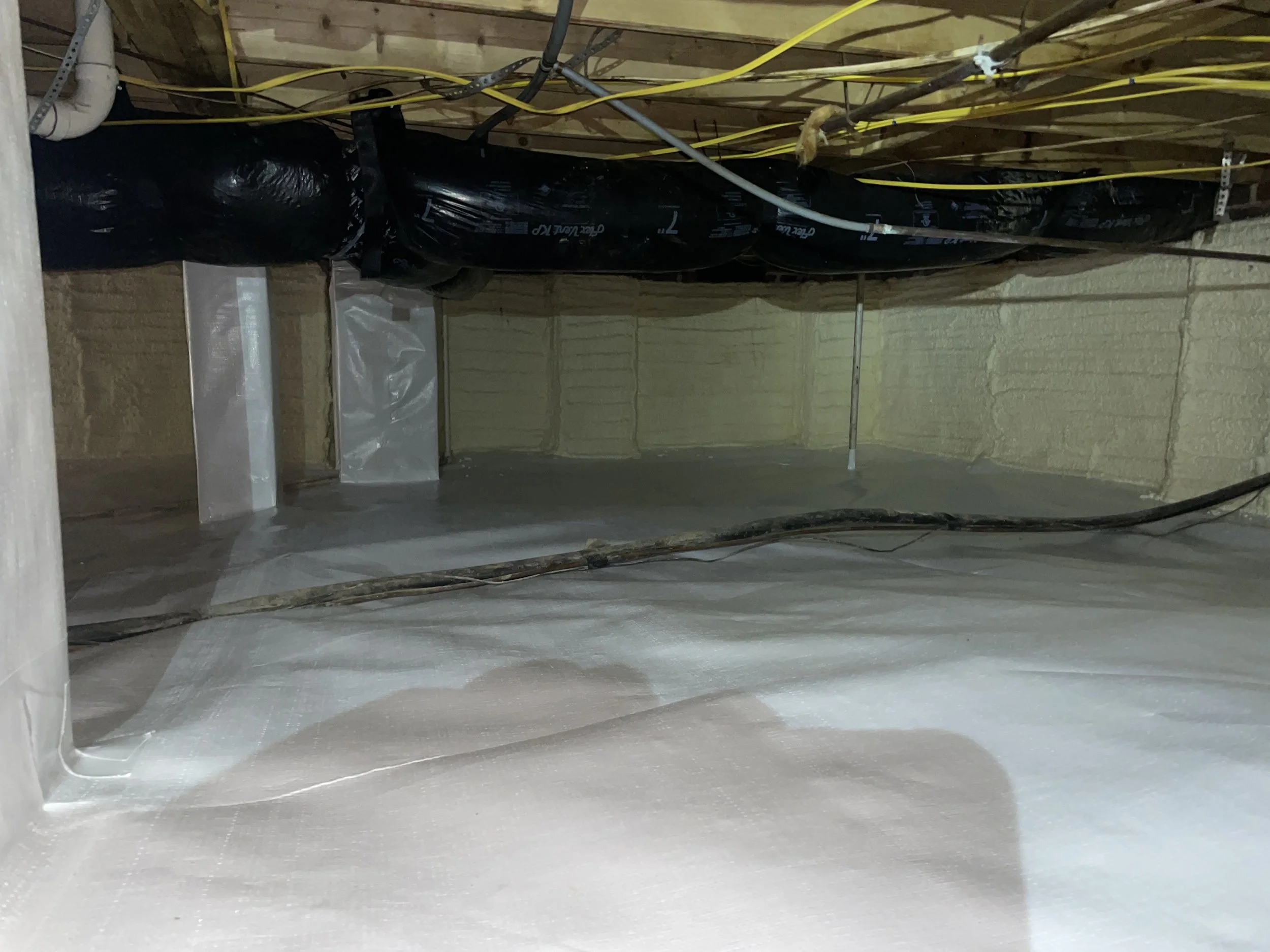 Encapsulated crawl space in Troutman with a sealed vapor barrier, wrapped piers, spray foam foundation wall insulation and crawl space dehumidifier