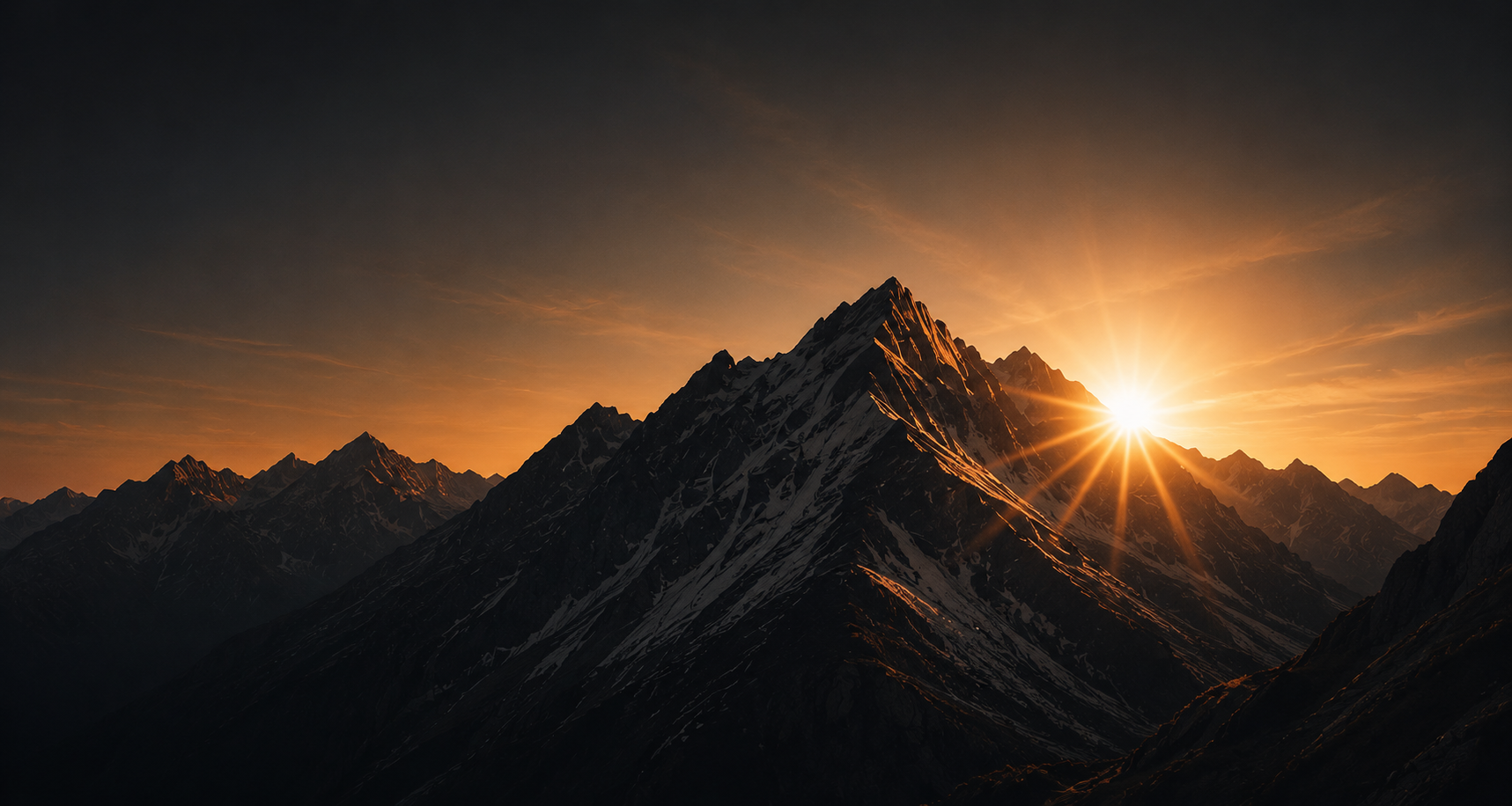 Sunset over snowy mountain peaks - The Second Summit HQ