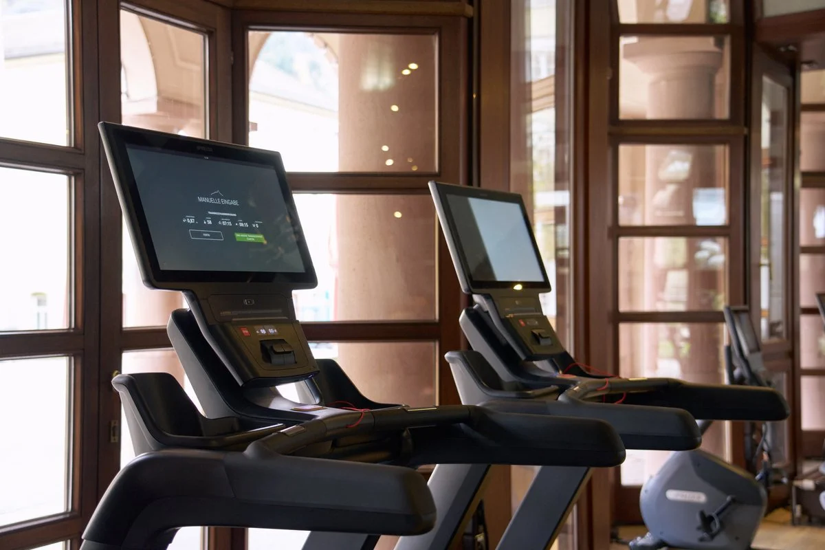 People running on treadmills at a gym