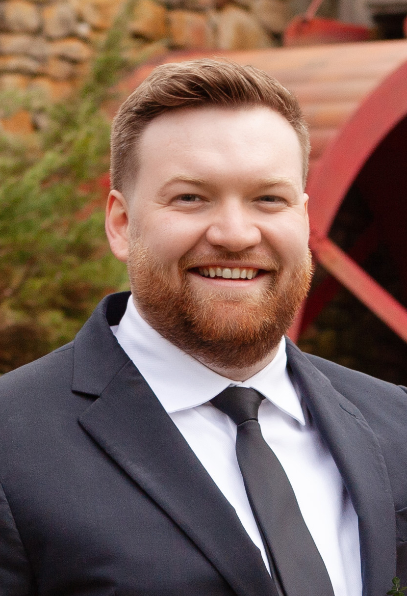 Founder of North & James AI consulting wearing a suit outdoors, Greater Boston small business consultant