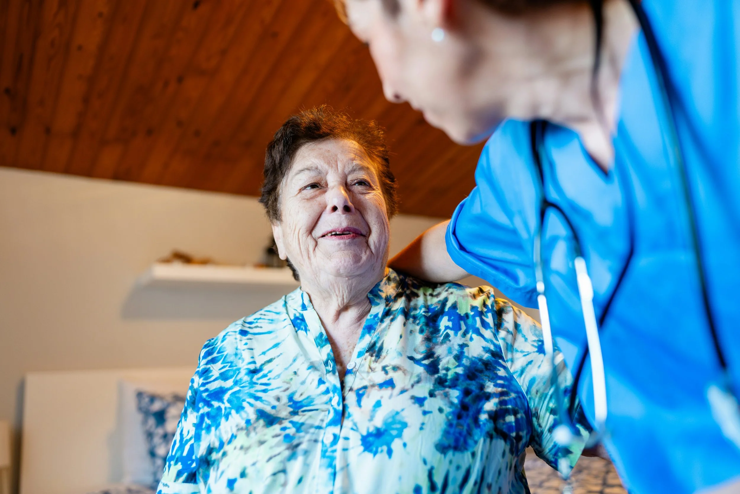 A private nurse advocate and an elderly client are talking during a home visit in the client's home in Raleigh, NC.
