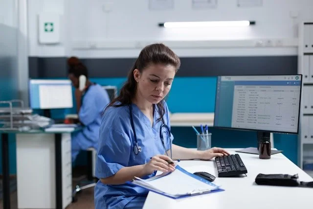 Private RN patient advocate coordinating a client's medical care and organizing medical records after a home visit with senior citizen. She is creating a health status report for the client and client's family.