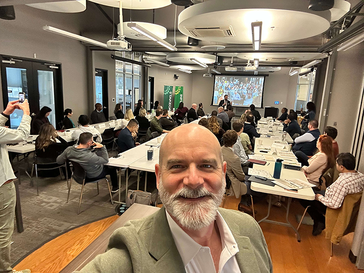 Johnny Anderson in a room of business leaders
