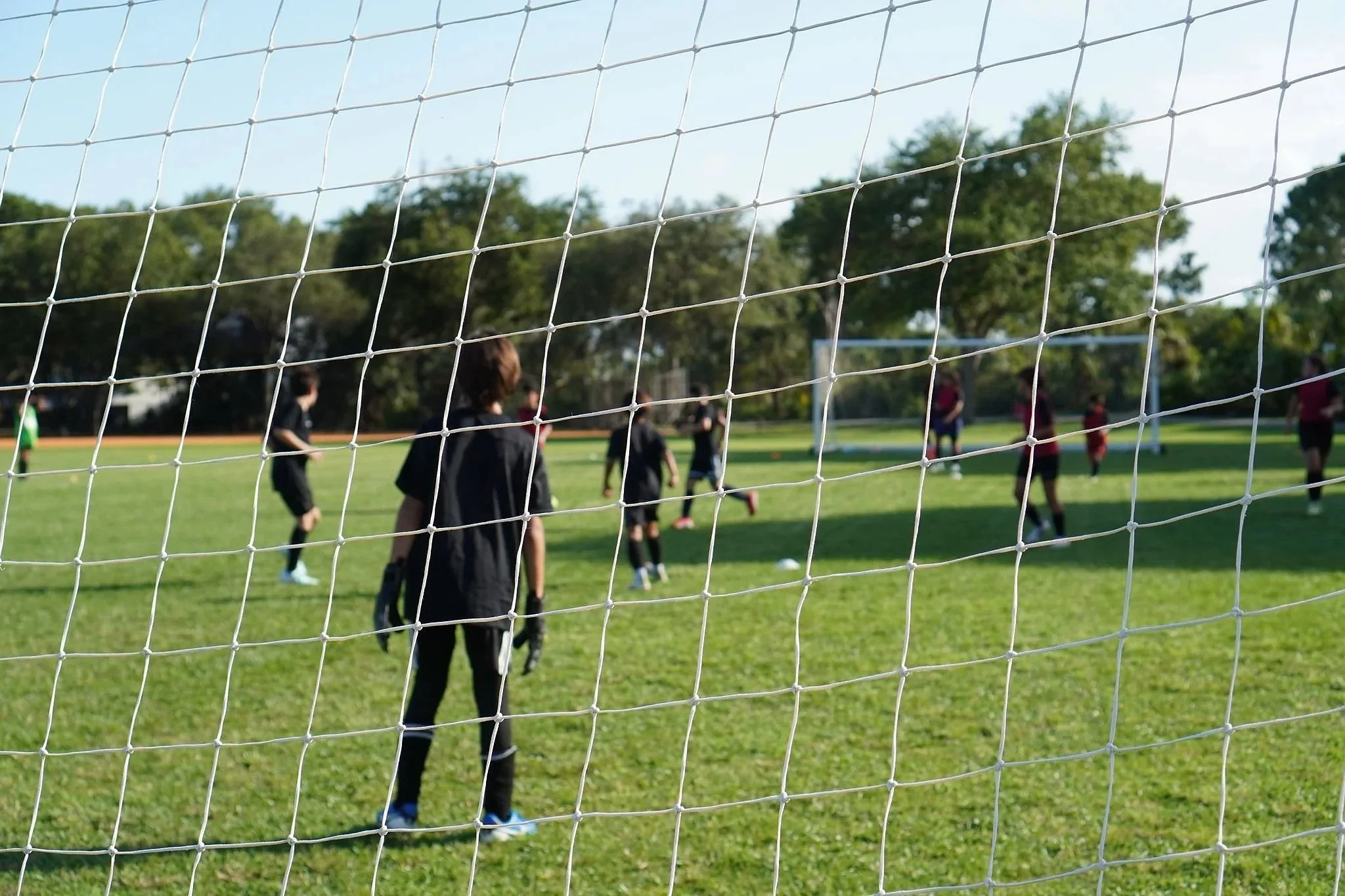 Players participating in a Top 1 Soccer Training summer soccer camp at Coral Reef Park